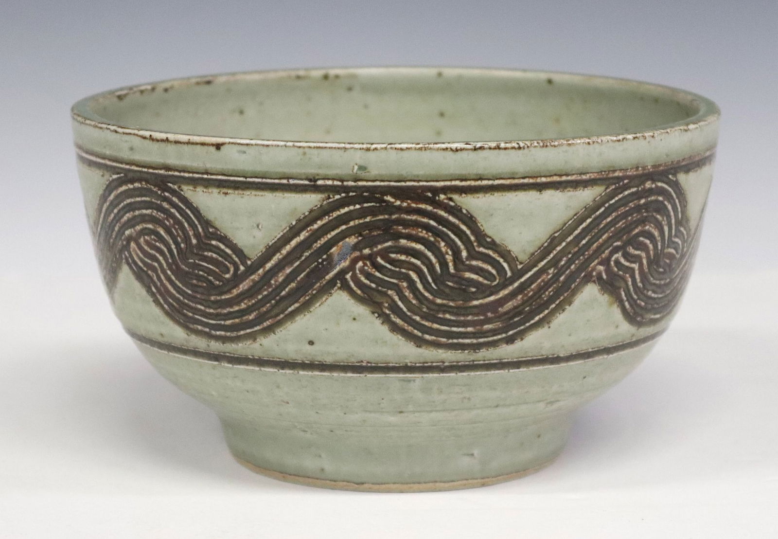 ERIK REIFF (1923-2006) ROYAL COPENHAGEN GLAZED STONEWARE FOOTED BOWL: Celadon-glazed stoneware pottery footed bowl, Erik Reiff (Danish, 1923-2006) for Royal Copenhagen, Denmark, signed with artist's monogram and dated [19]82 underfoot, band with incised wave pattern