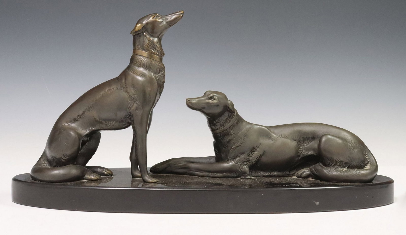 LARGE ART DECO STYLE SCULPTURE PAIR OF BORZOIS, 9.5"H X 19.5"L: Art Deco style patinated metal sculpture, depicting one seated and one recumbent dog, on a black stone base, overall: approx 9.5"h, 19"w, 6.5"d, 15.5lbs
