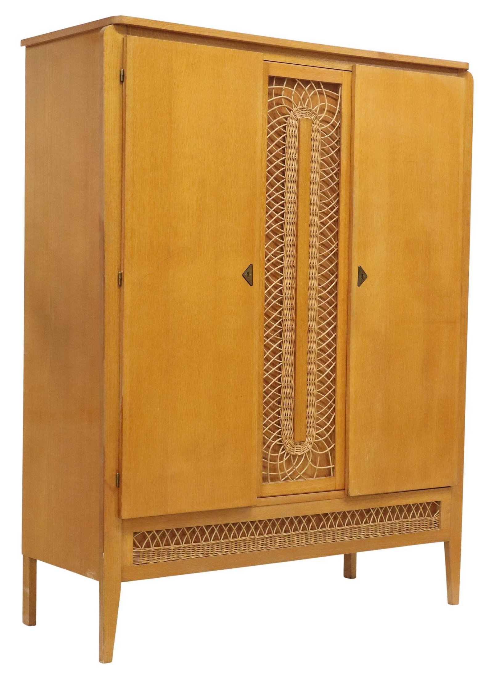 FRENCH MID-CENTURY MODERN OAK & RATTAN ARMOIRE: French mid-century modern oak armoire, c.1960s, central woven rattan panel, flanked by side cabinet doors, interior with shelves and hanging rod, a single exterior drawer below with rattan accent, on