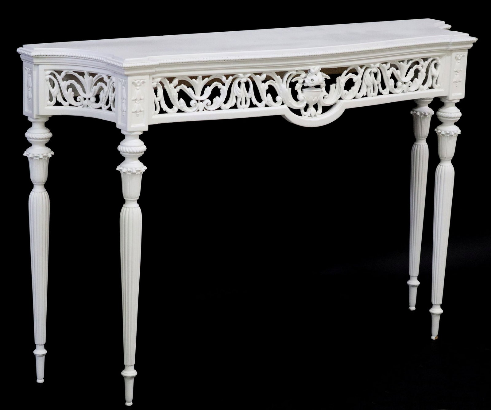 LOUIS XVI STYLE WHITE PAINTED CONSOLE TABLE: Louis XVI style white painted console table, late 20th c., having inset top, over scrolled foliate frame, rising on fluted and tapered legs, some small areas of paint loss, approx 