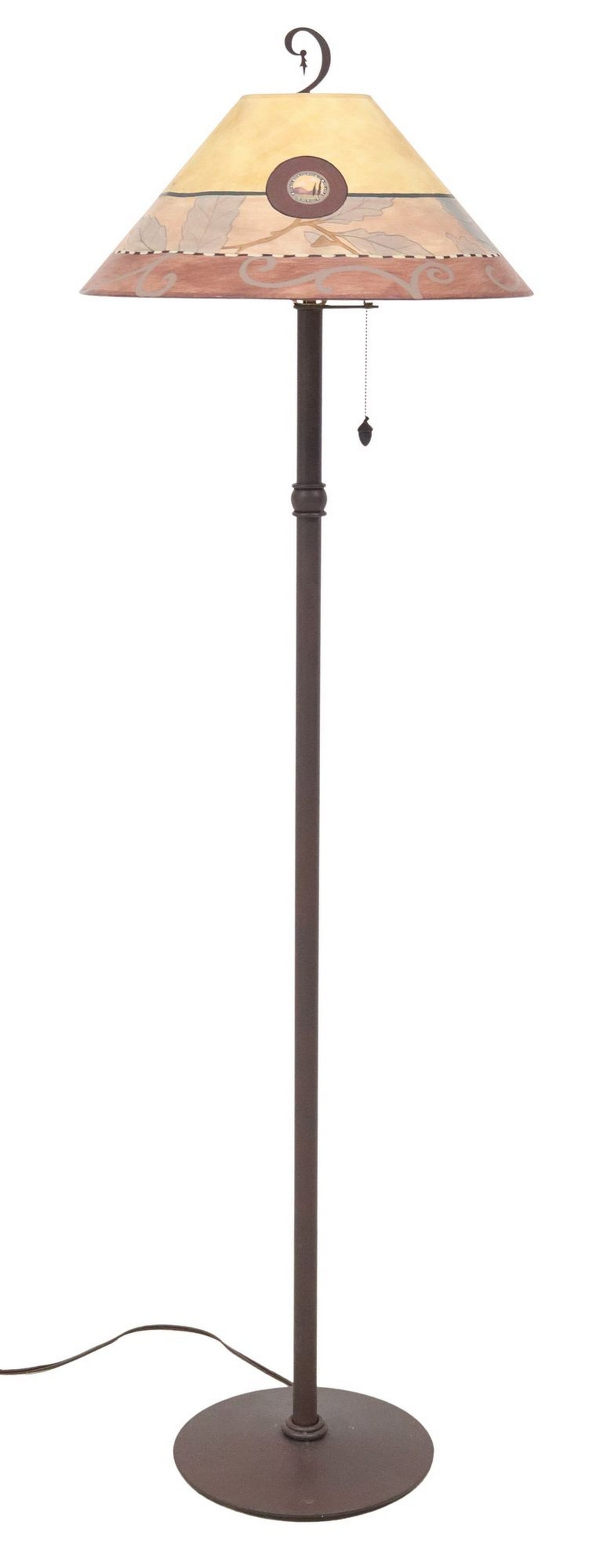 JANNA UGONE CRAFTSMAN-STYLE PAINTED FLOOR LAMP: Craftsman-style floor lamp, shade signed Ugone (Janna Ugone & Company), dated 1999, painted shade banded by oak leaves, central roundel with landscape, single light, pull chain with acorn finial, 