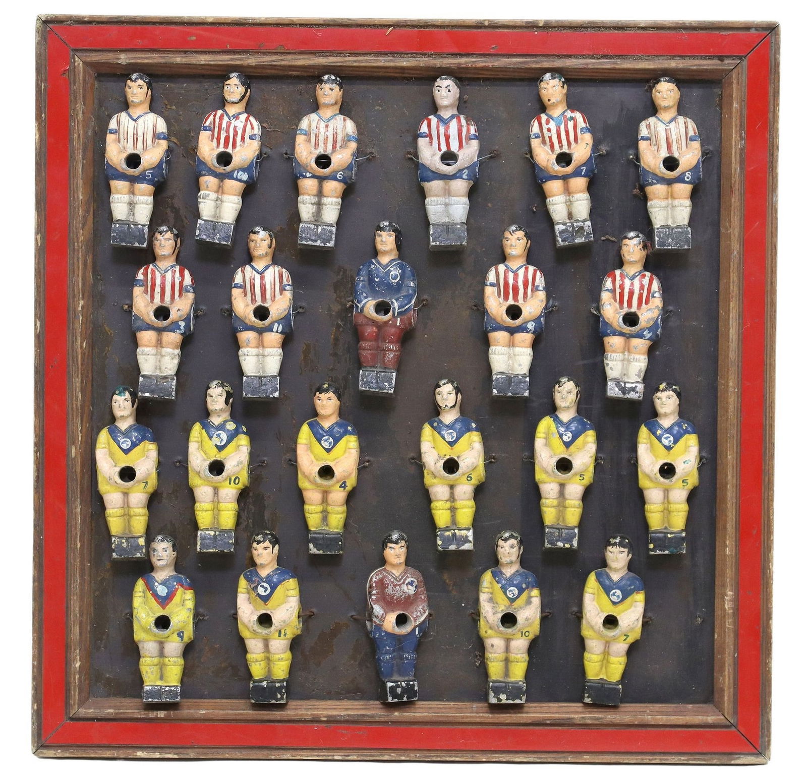 FRAMED COLLAGE COMPRISED OF 22 VINTAGE METAL FOOSBALL FIGURES: Framed collage, consisting of twenty-two vintage metal foosball/ table soccer figures, each with hand-painted uniform and features, overall: approx 19"h, 19.25"w, 10lbs 