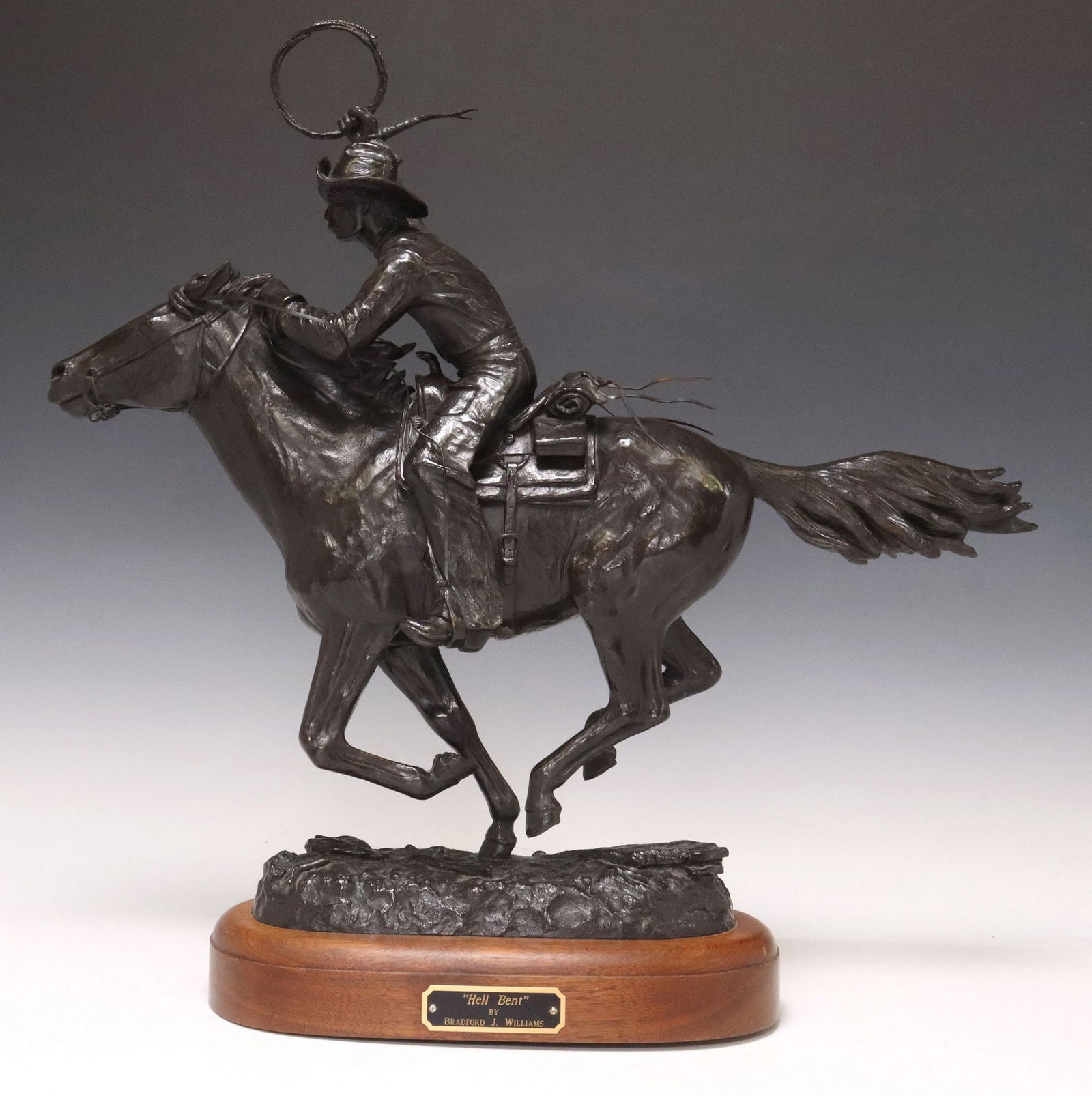 BRADFORD WILLIAMS (B.1948) WESTERN BRONZE SCULPTURE, 'HELL BENT': Patinated bronze sculpture, "Hell Bent," signed in cast Bradford J. Williams (Colorado/ Arizona, b.1948), numbered 2/ 30, dated [19]99, rising on wood swivel base with central title pla