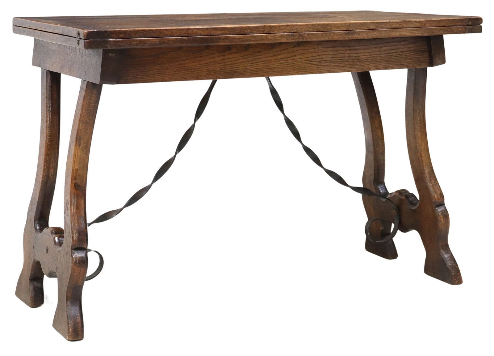 SPANISH BAROQUE STYLE OAK FLIP-TOP TABLE: Spanish Baroque style oak table, 20th c., hinged top, on trestle supports, joined by wrought iron cross stretchers, closed: approx 28.75"h, 43"w, 21.75"d, open: approx 27.75"h, 43&