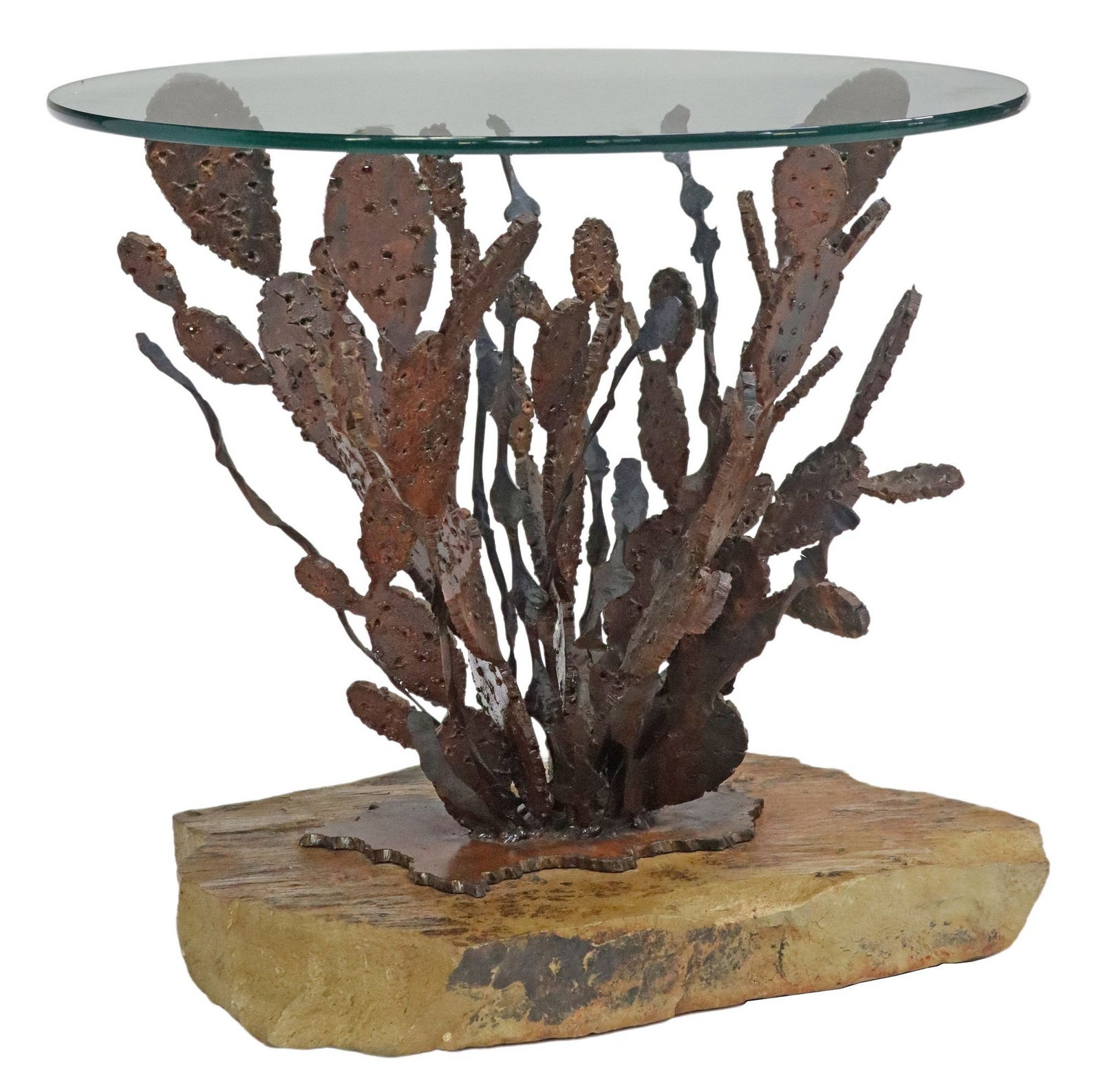 TORCH-CUT IRON & GLASS-TOP CACTUS SIDE TABLE ON STONE BASE: Torch-cut iron cactus side able, having circular glass top, rising on natural stone base, approx 20"h, 22"w **Provenance: A luxury home in Westlake Hills, Texas**