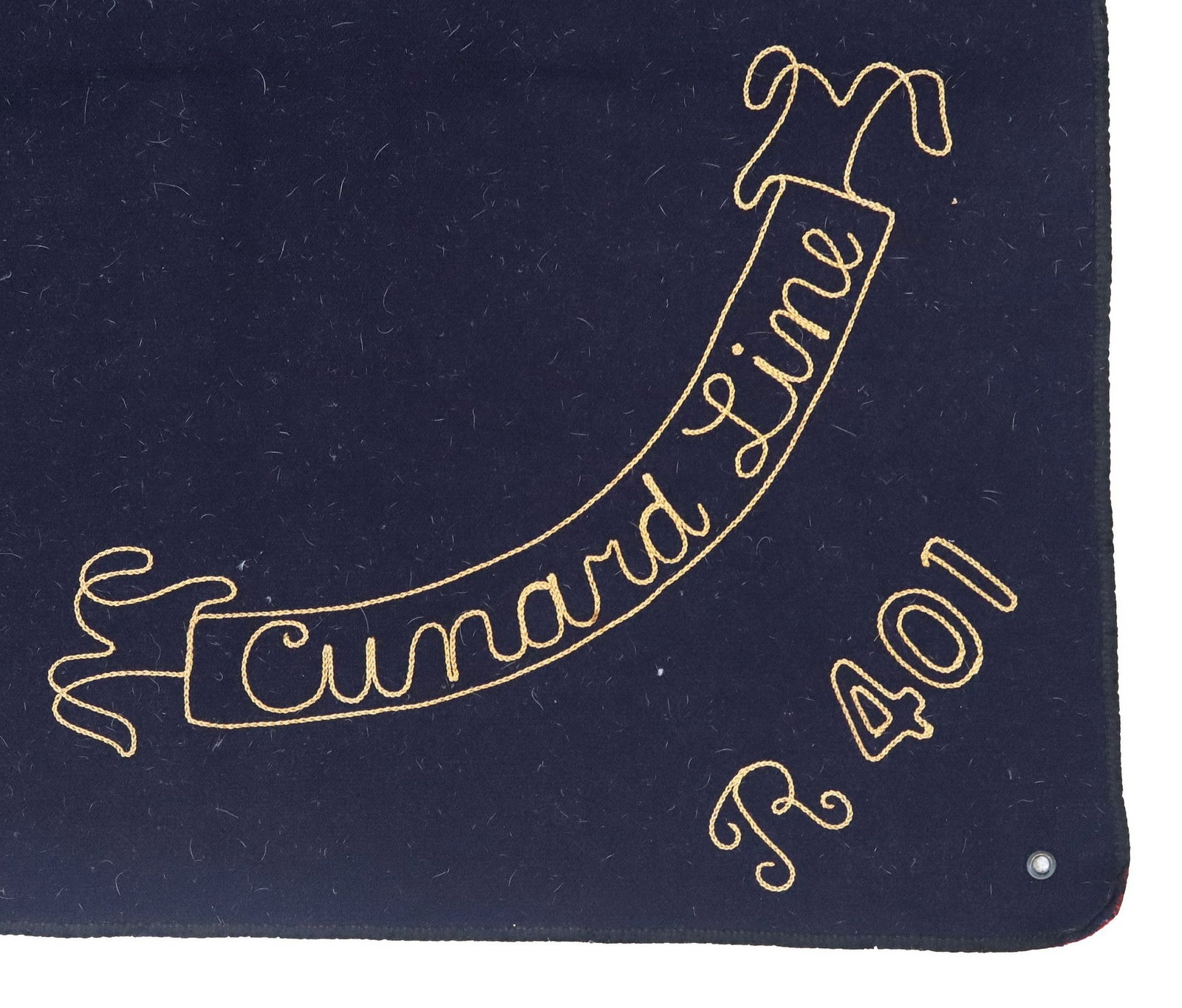 COMMEMORATIVE CUNARD LINE WOOL SHIP DECK/ STEAMER RUG BLANKET: Commemorative Cunard Line wool steamer rug/ ship deck blanket, early-mid 20th c., in solid navy and red with contrast black trim, embroidered sash inscribed "Cunard Line R401," approx 6