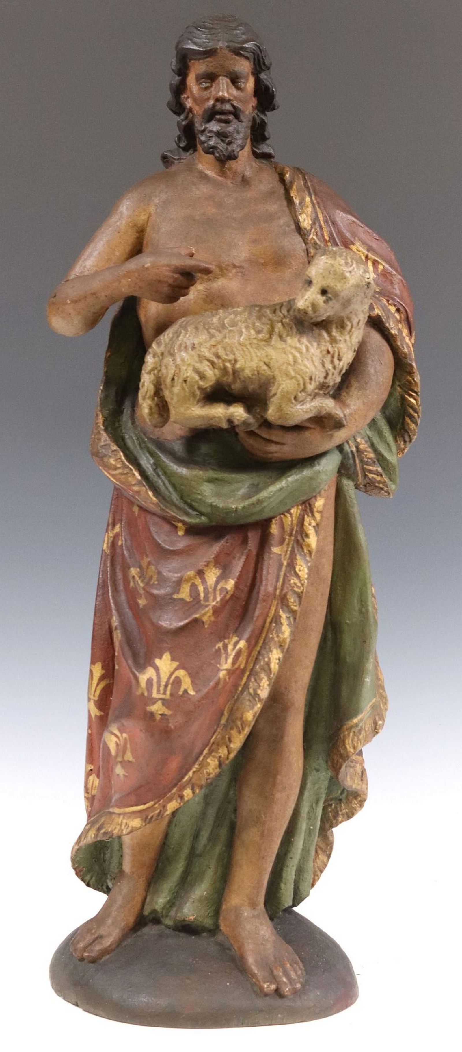 ITALIAN CARVED & PAINTED SCULPTURE ST JOHN THE BAPTIST: Italian altar figure, Saint John the Baptist, gesso over wood with polychrome paint, depicted holding a lamb, symbolizing Christ as the Lamb of God, restoration to right arm a