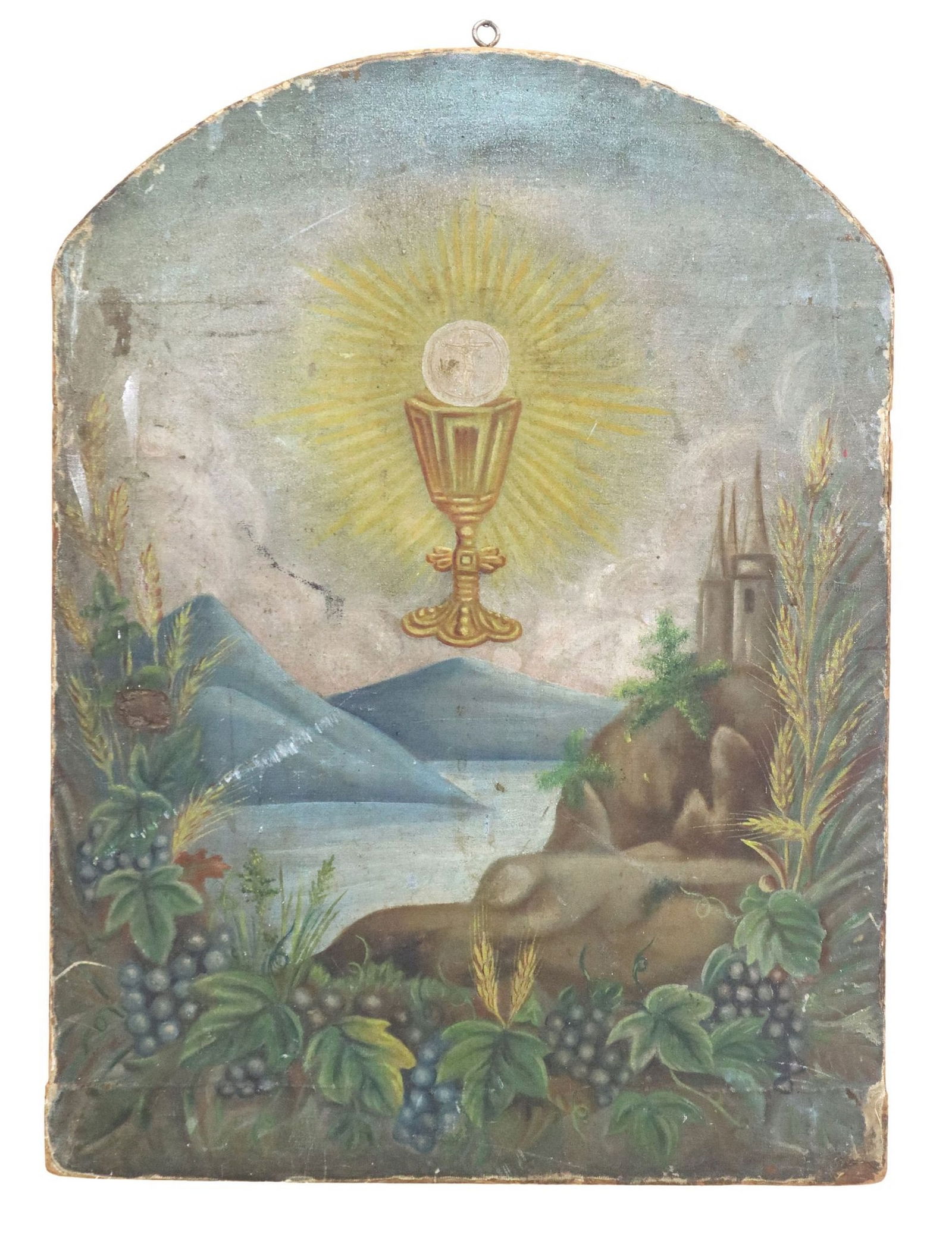 PAINTED HOLY EUCHARIST CHALICE & HOST TABERNACLE DOOR: Oil on canvas painting, mounted to a wood tabernacle door, Eucharistic chalice and host, the host bearing an image of the crucifixion, above a landscape with grapes and sheaves of wheat in the foregro