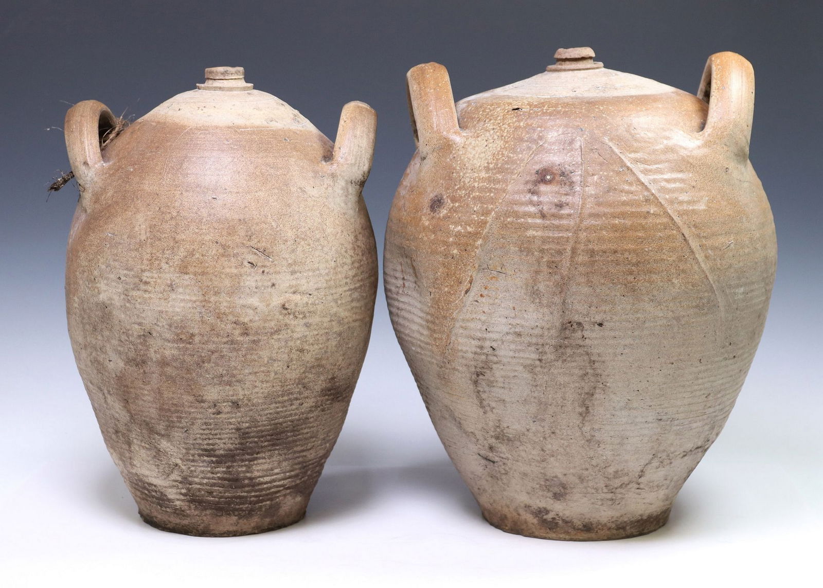 (2) FRENCH PROVINCIAL STONEWARE OIL JUGS: (lot of 2) French Provincial stoneware oil jugs, having tapered body, dual handles flanking mouth, largest: approx 17.5"h, 14.5"diam, 29lbs total