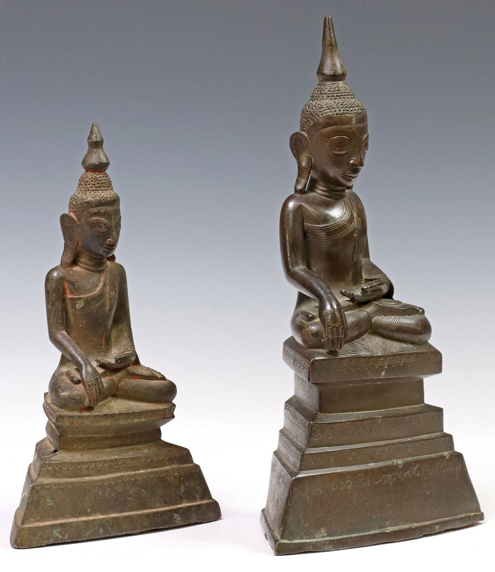 (2) SOUTHEAST ASIAN PATINATED METAL BUDDHAS IN BHUMISPARSHA MUDRA: (lot of 2) Southeast Asian patinated metal Buddha figures, each seated in the Bhumisparsha (earth touching) Mudra, on integral platform base, including: (1) approx 12"h, 6.25"w, 3&