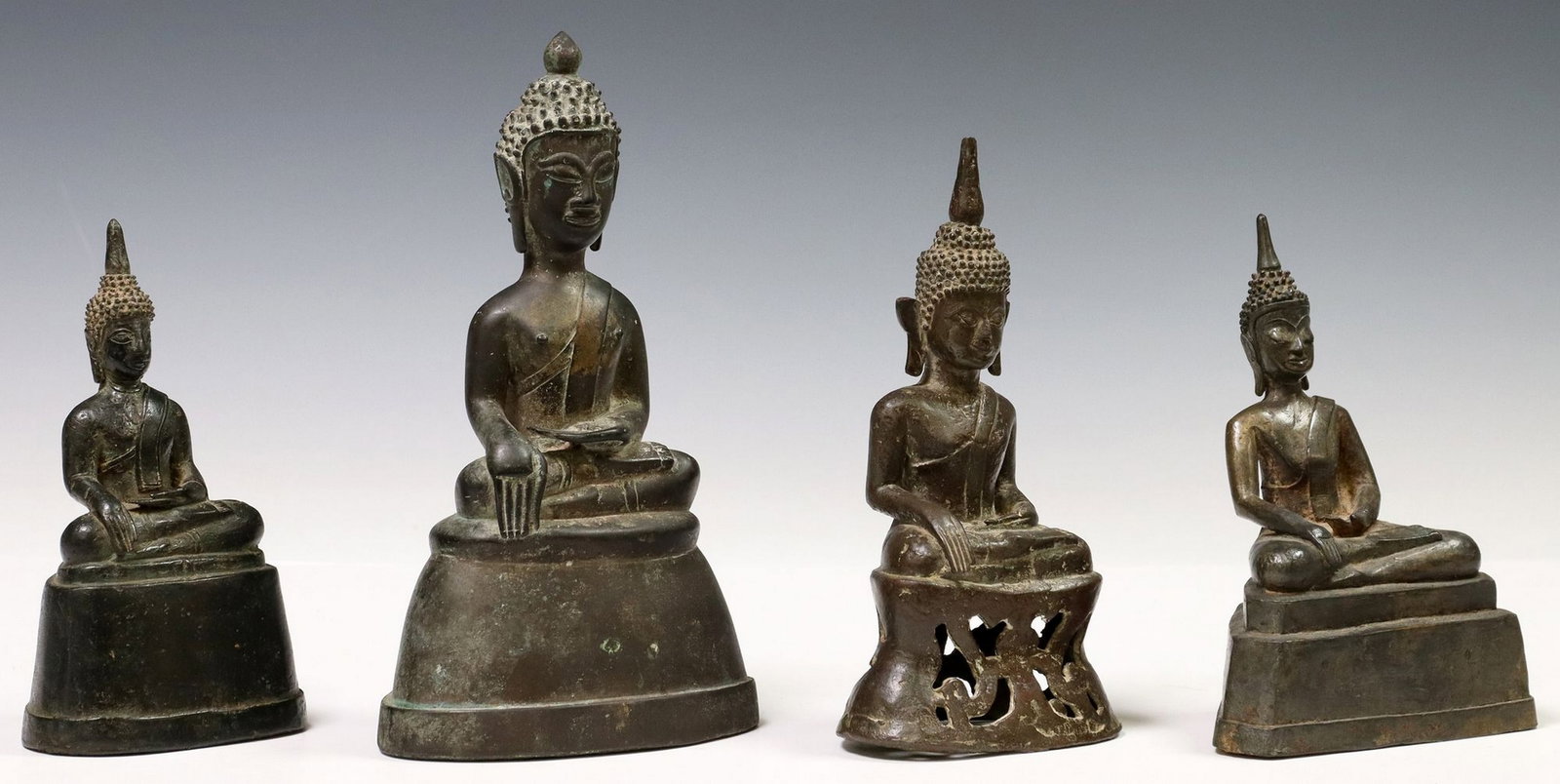 (4) SOUTHEAST ASIAN PATINATED METAL BUDDHAS IN BHUMISPARSHA MUDRA: (lot of 4) Southeast Asian patinated metal Buddha figures, each seated in the Bhumisparsha (earth touching) Mudra, on integral platform base, largest: approx 8.75"h, 5"w, 3.5"