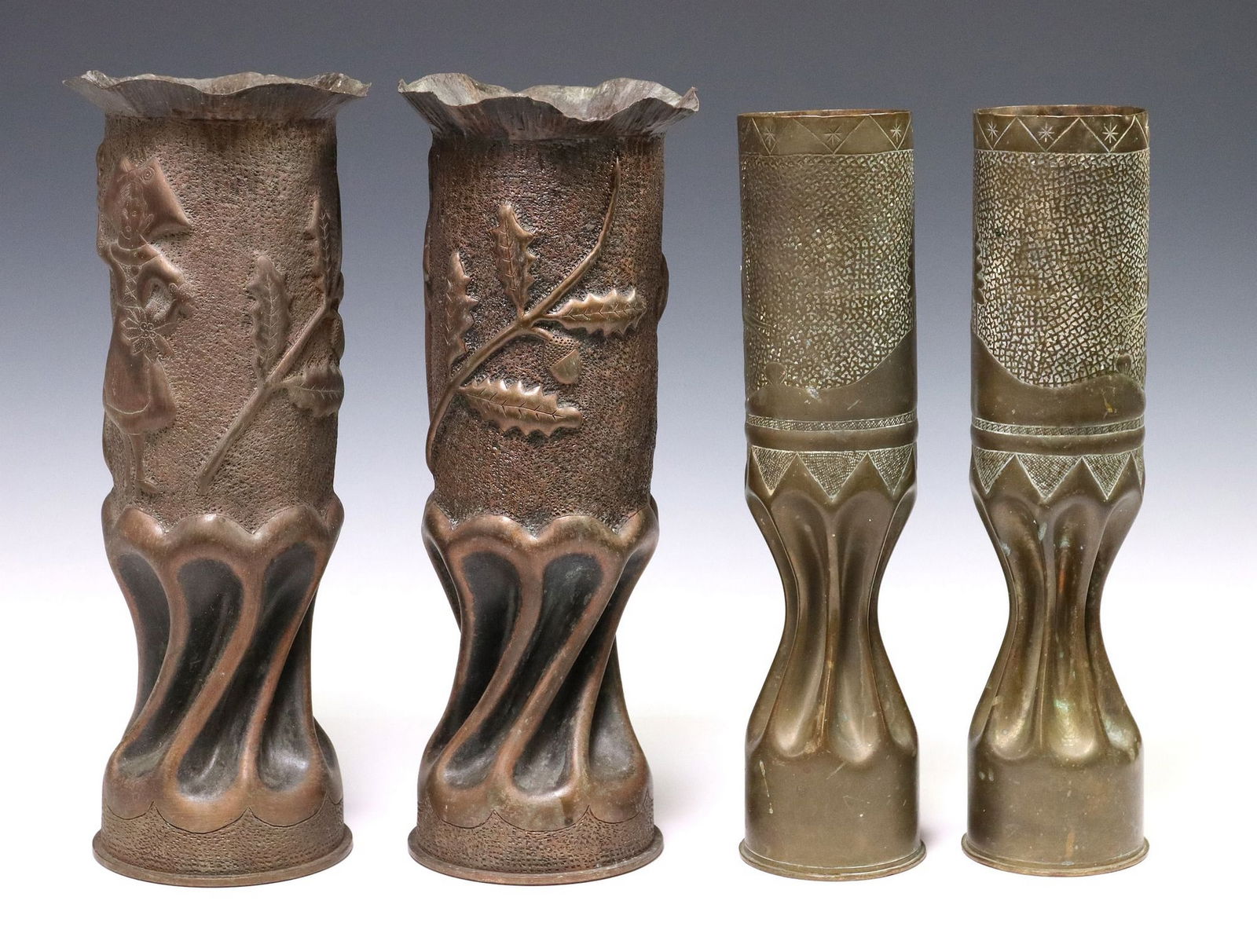 (4) FRENCH WWI & WWII-ERA TRENCH ART ARTILLERY SHELL VASES: (lot of 4) French WWI and WWII-era trench art vases, fashioned from artillery shells, including: (pair) large WWII-era vases, having flared rim, above central repousse figure flanked by foliate branch