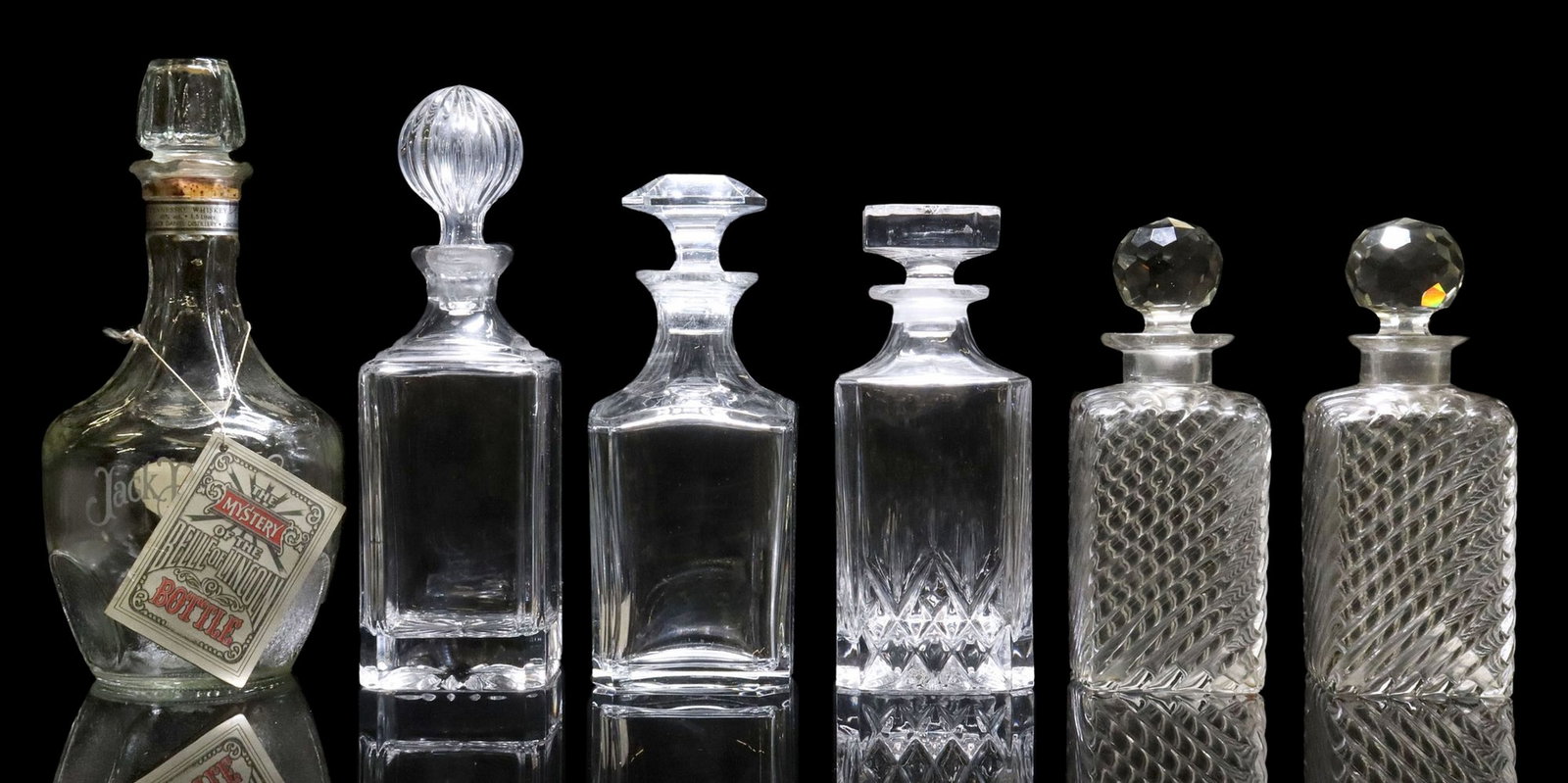 (6) GLASS SPIRIT DECANTERS: BACCARAT, JACK DANIEL'S & OTHERS: (lot of 6) Glass spirit decanters, including: (1) Baccarat "Perfection" decanter and stopper, retaining Denis-Mounie cognac label, imported for the Italian market by P.&n