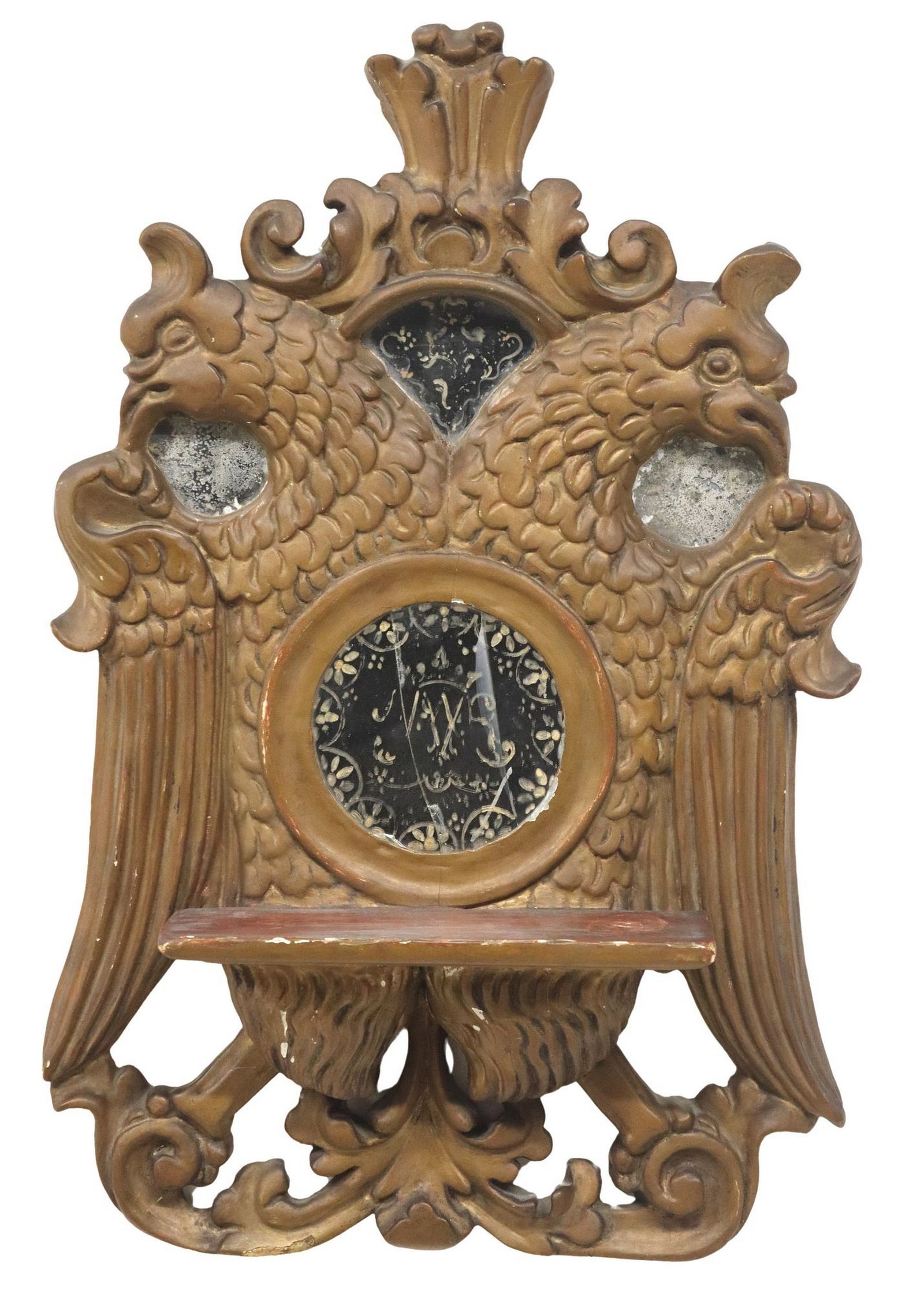 SPANISH COLONIAL STYLE DOUBLE-HEADED EAGLE LECTERN WALL MIRROR: Spanish Colonial style Habsburg eagle lectern/ wall mirror, late 19th c., in a gilt painted finish, having scrolled crown, over double-headed eagle and shallow shelf, with inset painted mirror plates,