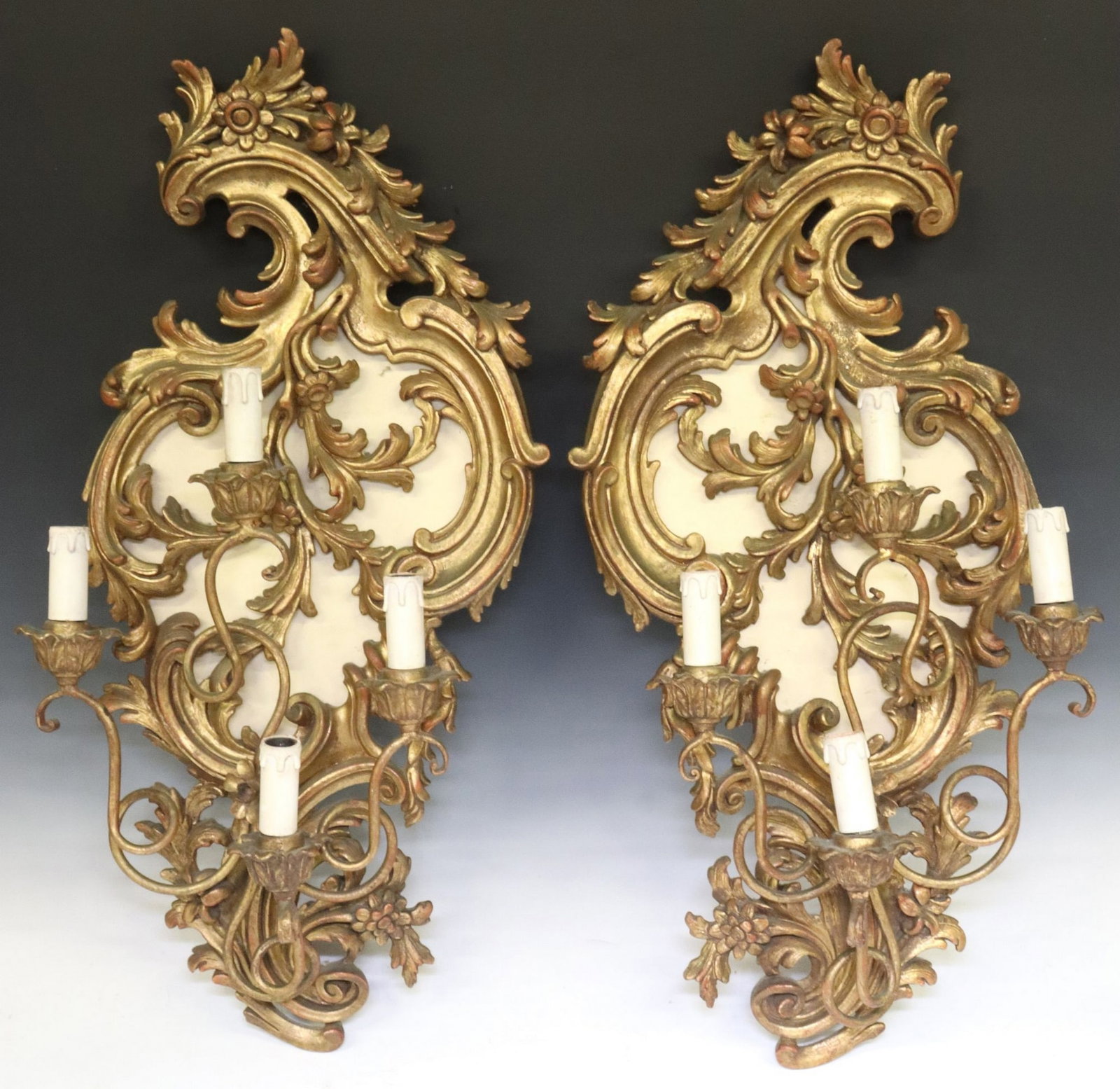 (2) ITALIAN LOUIS XV STYLE GILTWOOD 4-LT SCROLLED WALL SCONCES: (pair) Italian Louis XV style giltwood four-light wall sconces, early 20th c., each having scrolled foliate backplate with floral motifs, issuing four iron arms, each terminating on floral bobeche and