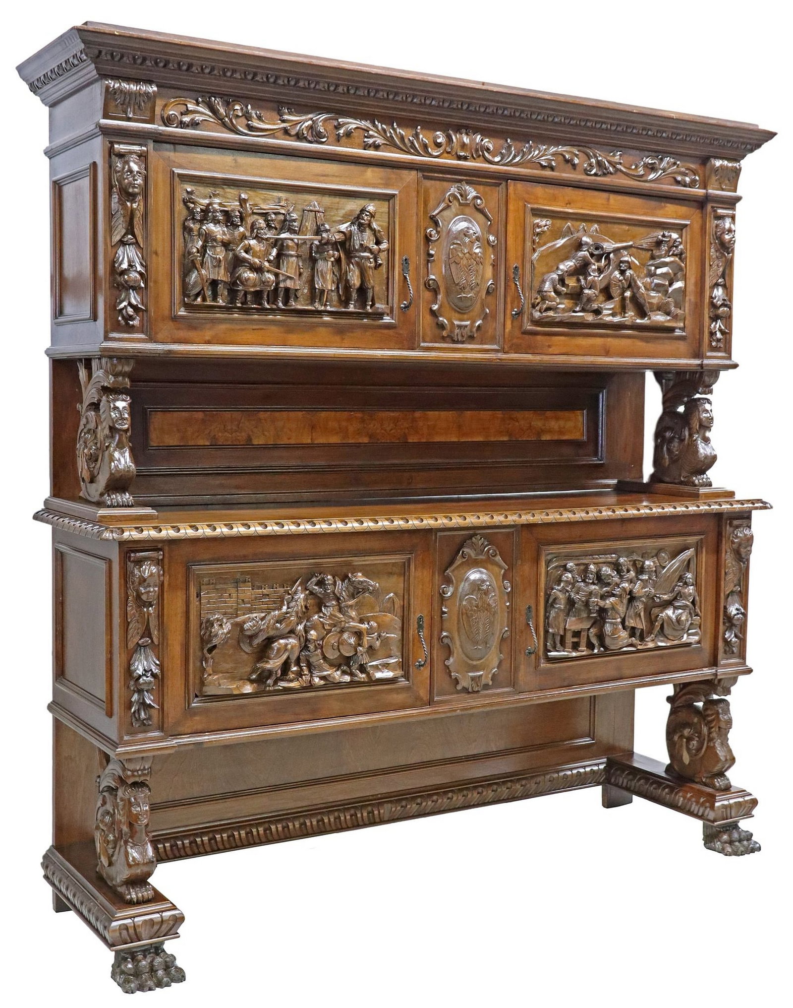 ITALIAN RENAISSANCE REVIVAL HIGHLY CARVED SIDEBOARD, JOAN OF ARC SCENES: Italian Renaissance Revival carved walnut sideboard, early 20th c., having stepped cornice with molded trim, over four cabinet doors revealing shelved interior, each raised on scrolled grotesque suppo