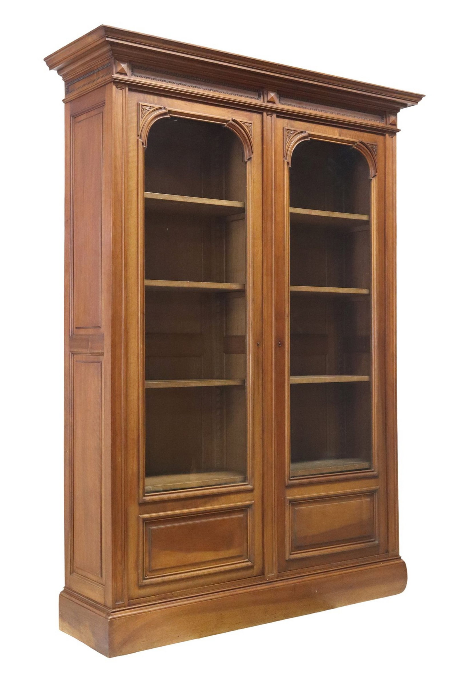 FRENCH NEOCLASSICAL STYLE MAHOGANY BOOKCASE: French Neoclassical style mahogany bookcase, early 20th c., having molded cornice, over double glazed doors with carved trim accented by subtle carved foliate branch, each door opening to four shelves