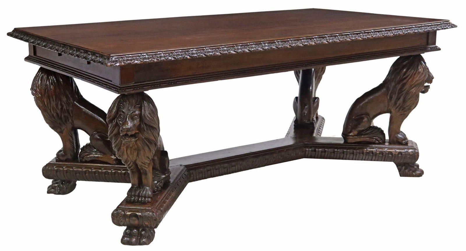 ITALIAN RENAISSANCE REVIVAL CARVED LIONS EXTENSION TABLE: Italian Renaissance Revival carved extension table, early 20th c., rectangular top with molded trim, with four pull-out slides to support leaves, rising on figural seated lion supports, over plat
