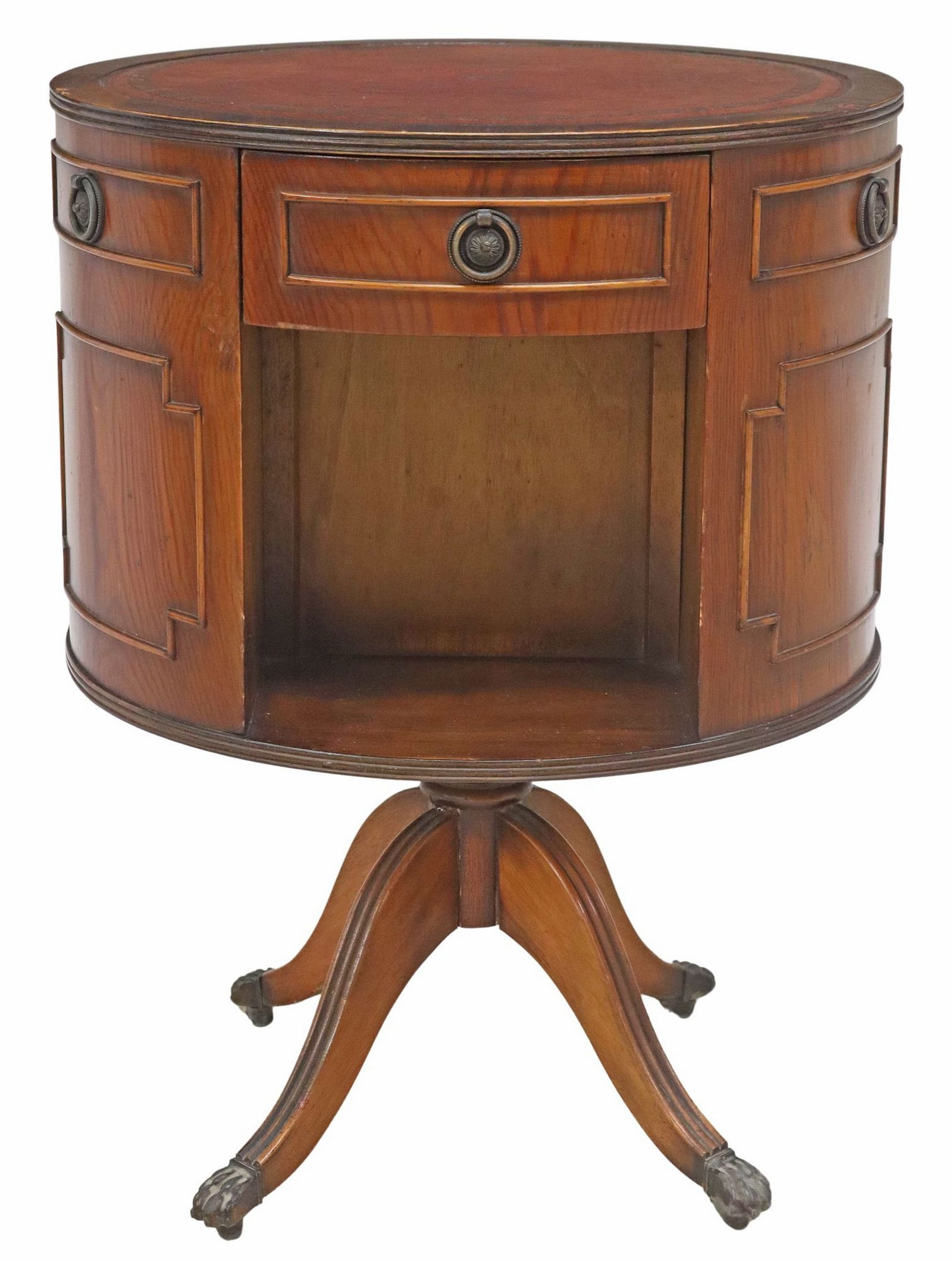 REGENCY STYLE LEATHER-TOP CIRCULAR ROTATING DRUM TABLE BOOKCASE: Regency style circular rotating drum table bookcase, 20th c., having leather top with gilt-embossed designs, over three drawers with three open storage, rising on fluted supports, ending on paw feet c