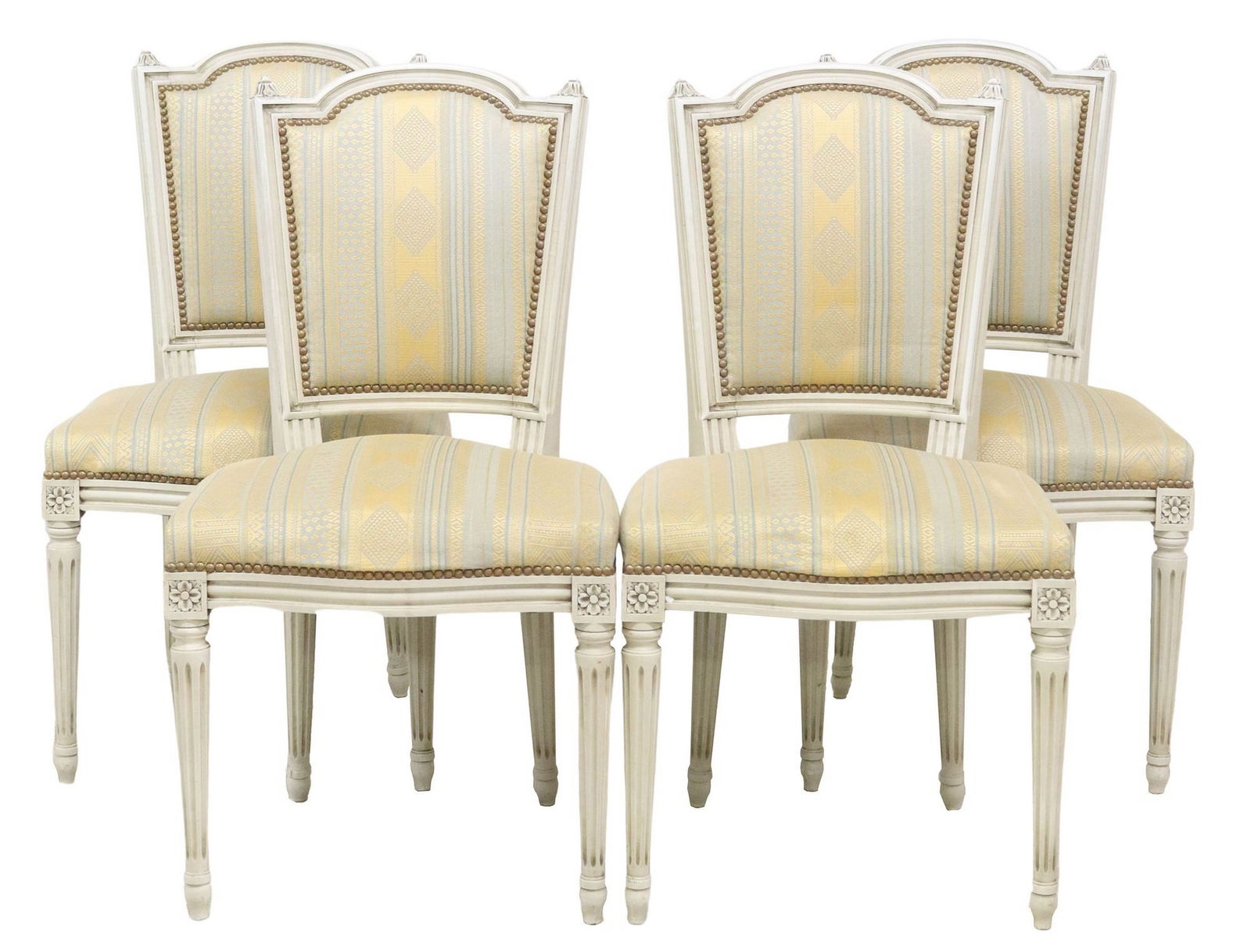 (4) FRENCH LOUIS XVI STYLE UPHOLSTERED DINING CHAIRS: (lot of 4) French Louis XVI style side chairs, 20th c., each in a white painted finish, with padded back and seat in patterned fabric upholstery, nailhead trim, rising on fluted tapered legs, ending o