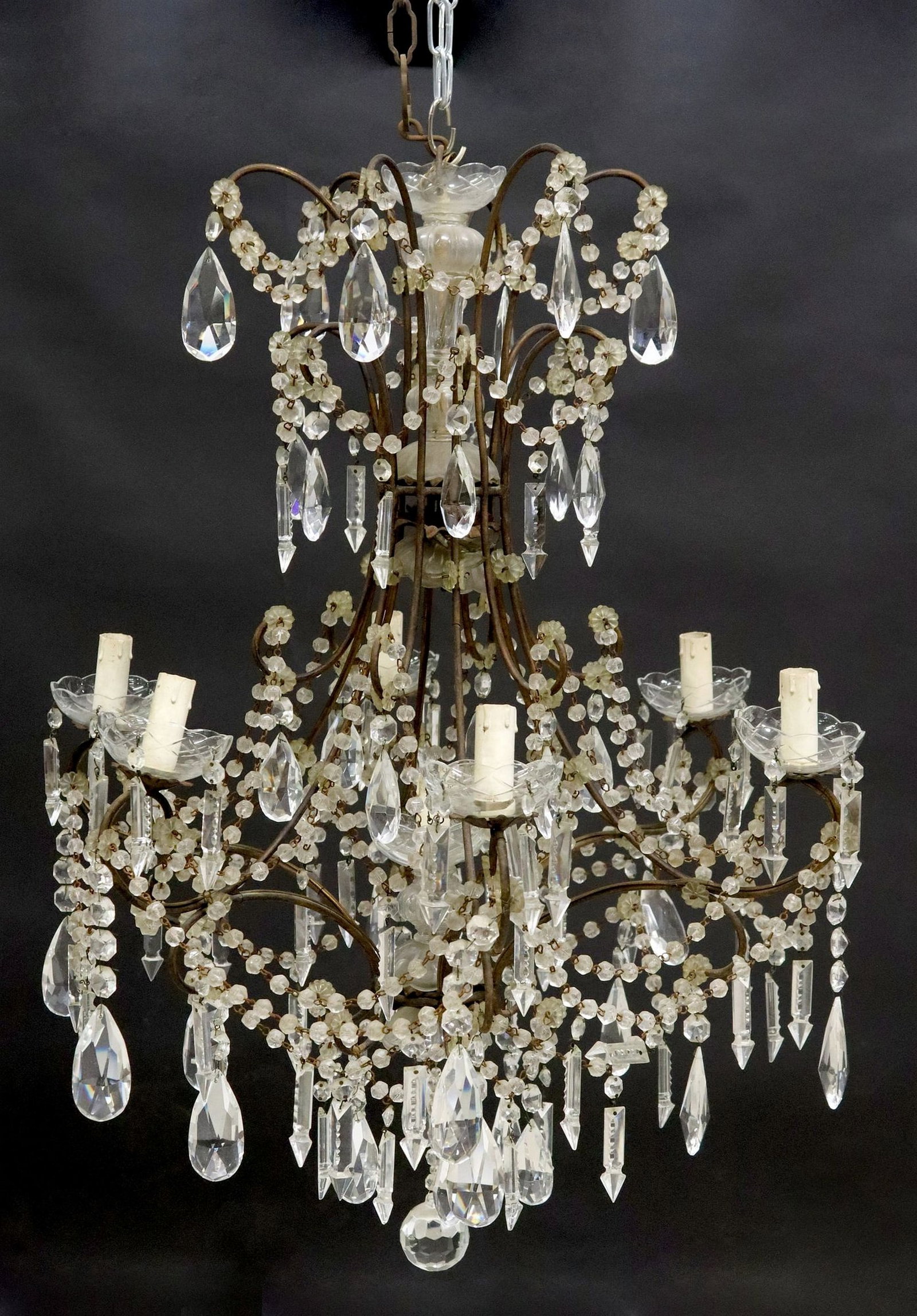 ITALIAN IRON & CRYSTAL SWAG SCROLLED FRAME 7-LIGHT CHANDELIER: Italian iron and crystal seven-light chandelier, early 20th c., having scrolled frame with applied floral beads, issuing six arms and central pedestal, each terminating on scalloped bobeche and faux c