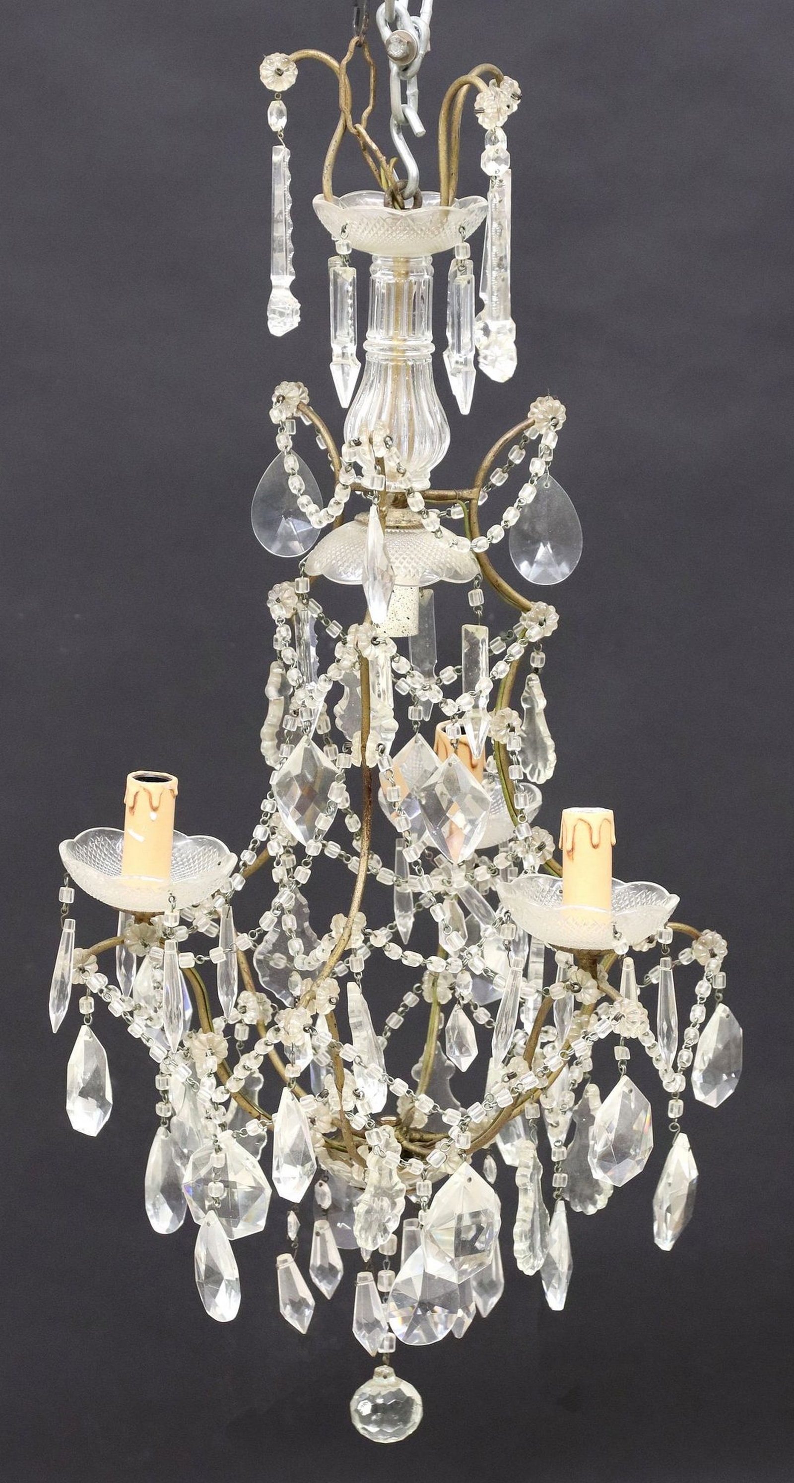 ITALIAN SCROLLED FRAME IRON & CRYSTAL SWAG BEADED 4-LT CHANDELIER: Italian iron and crystal four-light chandelier, early 20th c., having scrolled frame with beaded swag, concealing central interior light and issuing three arms, each terminating on scalloped bobeche a
