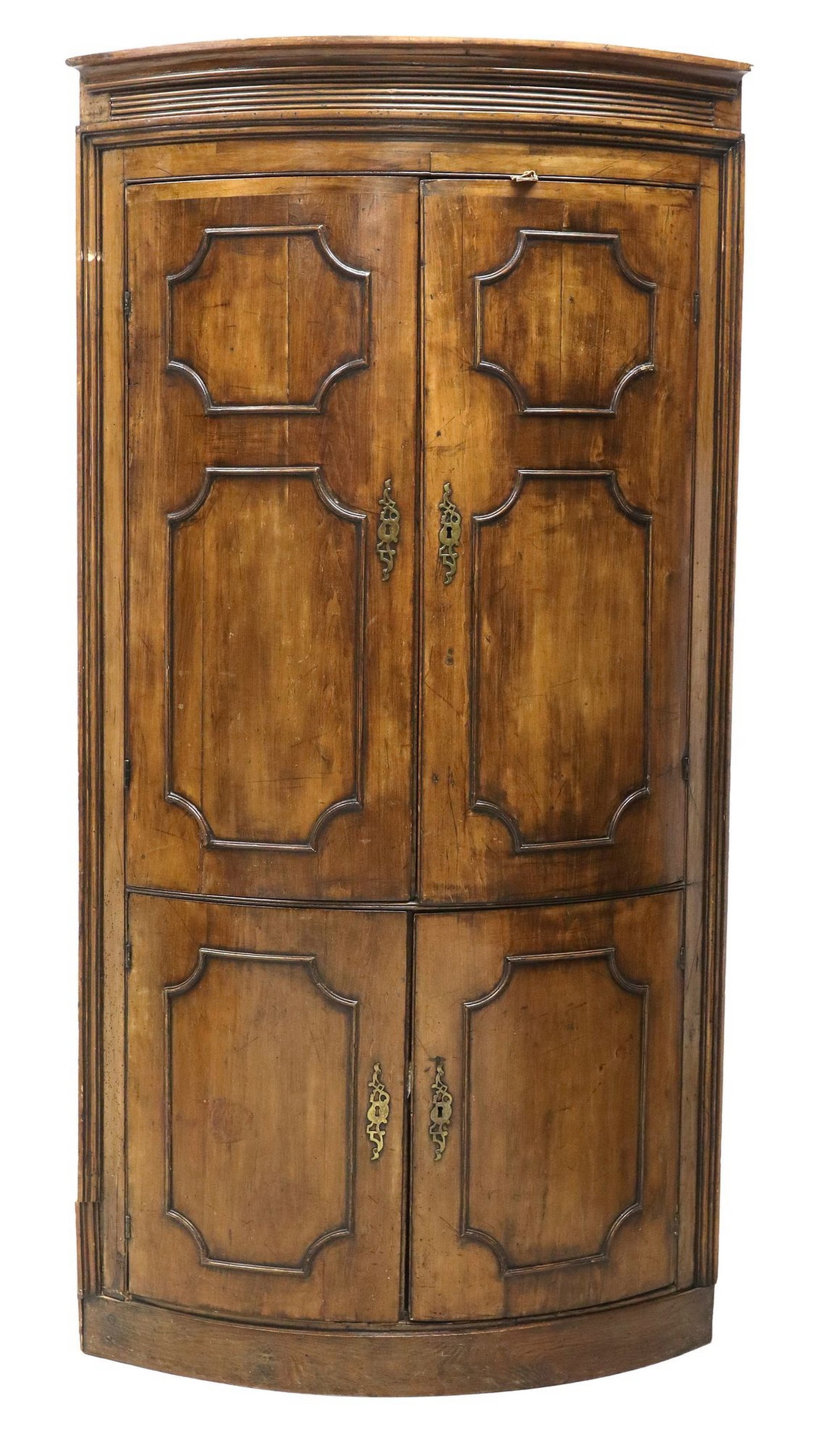FRENCH BOW FRONT CORNER CABINET, 19TH C.: French walnut bow-front corner cabinet, 19th c., having protruding cornice, above dual cabinet doors, opening to shelved storage, rising on conforming base, approx 75"h, 35"w, 25.5"d