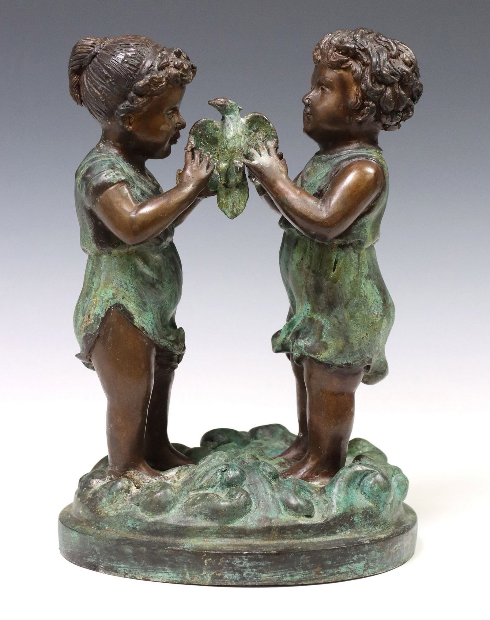 PATINATED BRONZE SCULPTURE CHILDREN WITH BIRD: Patinated bronze sculpture, Boy and Girl with a Bird, approx 12"h, 8.5"w, 7.5"d, 10.25lbs