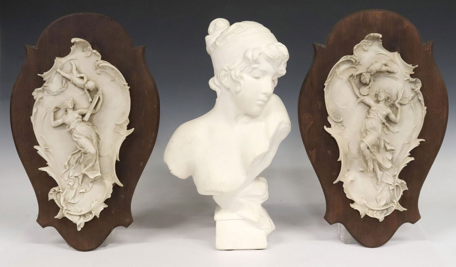 (3) ROCOCO STYLE RELIEF PLAQUES & CAST PLASTER BUST: (lot of 3) Decorative objects, including: (1) cast plaster bust of a demure lady, approx 16"h, (2) cartouche-shape resin wall plaques, depicting nymphs in diaphanous gowns accompanied by put