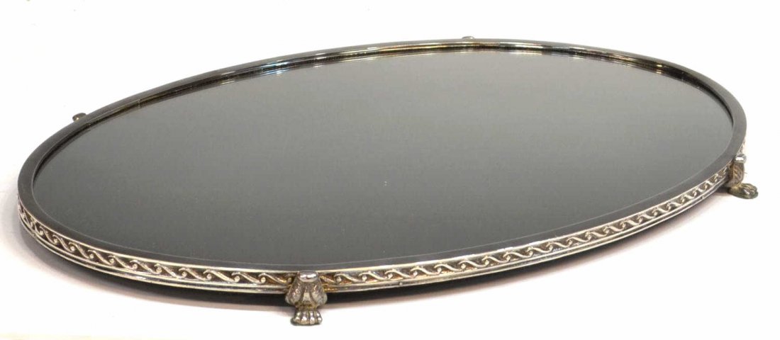 LARGE OVAL SILVER PLATE PAW FOOT PLATEAU MIRROR: Large mirrored table plateau of oval form having an abstract wave border, raised on for paw feet, 23"w, 15"d, 8lbs Start Price: $100.00