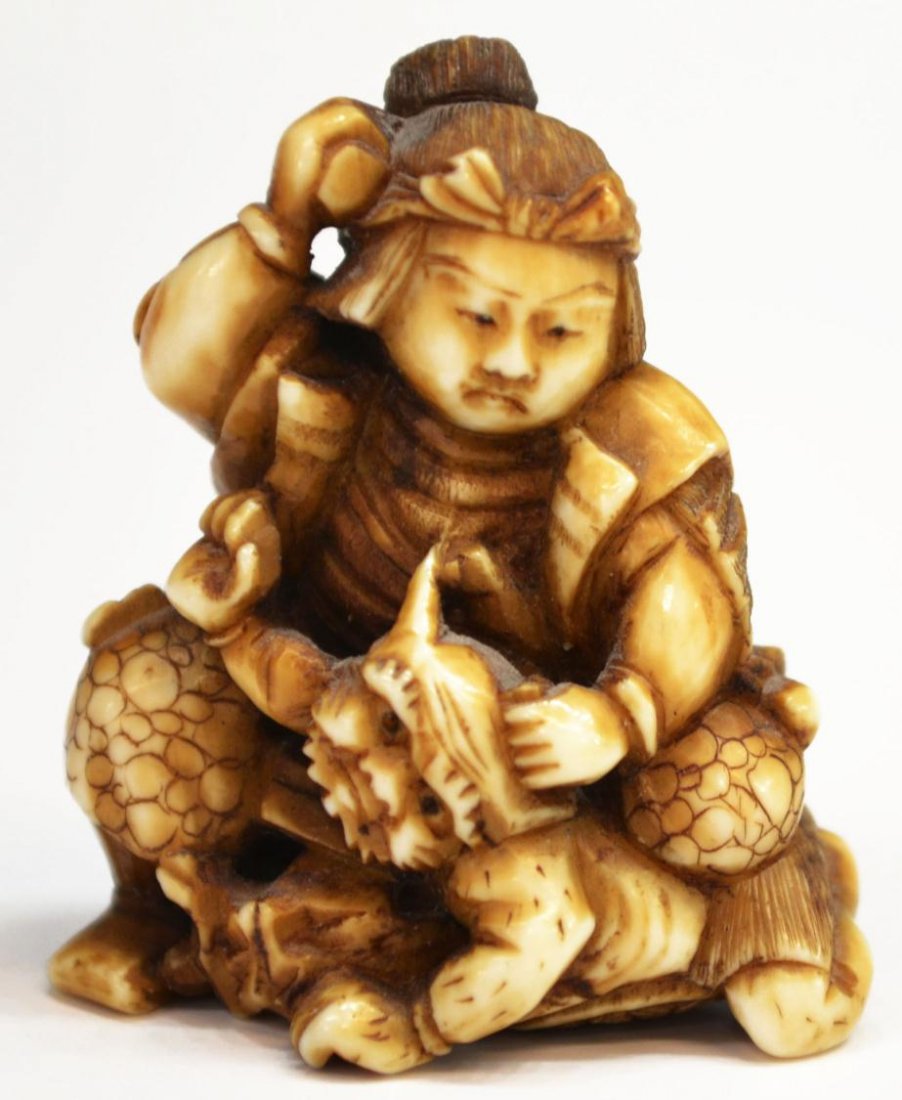 JAPANESE SAMURAI FIGURAL CARVED NETSUKE: ***International shipping is not available on this lot*** Japanese carved ivory netsuke, 19th c., a samurai warrior and masked creature, possibly lacking sword, 1.5"h, 1"w, .25lbs Start Price: $100.00