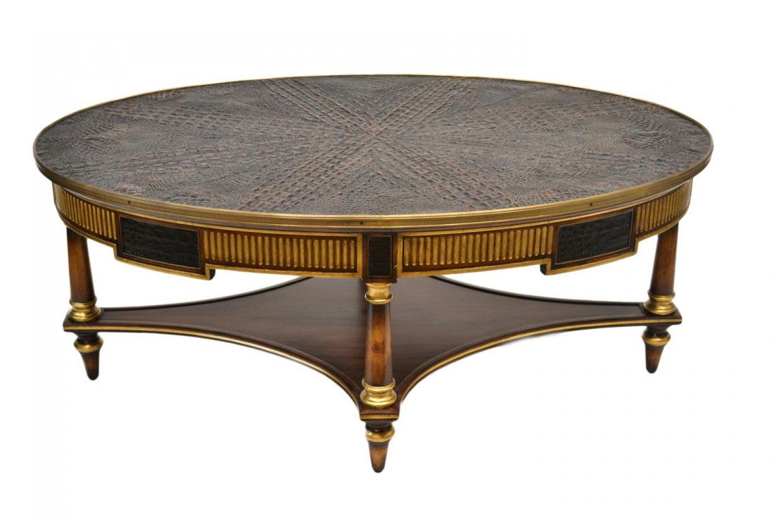 JOHN RICHARD FAUX CROCODILE COFFEE TABLE: John Richard coffee table, new, oval with metal edge framing a crocodile print leather top, set on turned legs joined by stretcher shelf, 21.5"h, 51.25"w, 32"d **Provenance: Lou's Antiques and Fine Fu