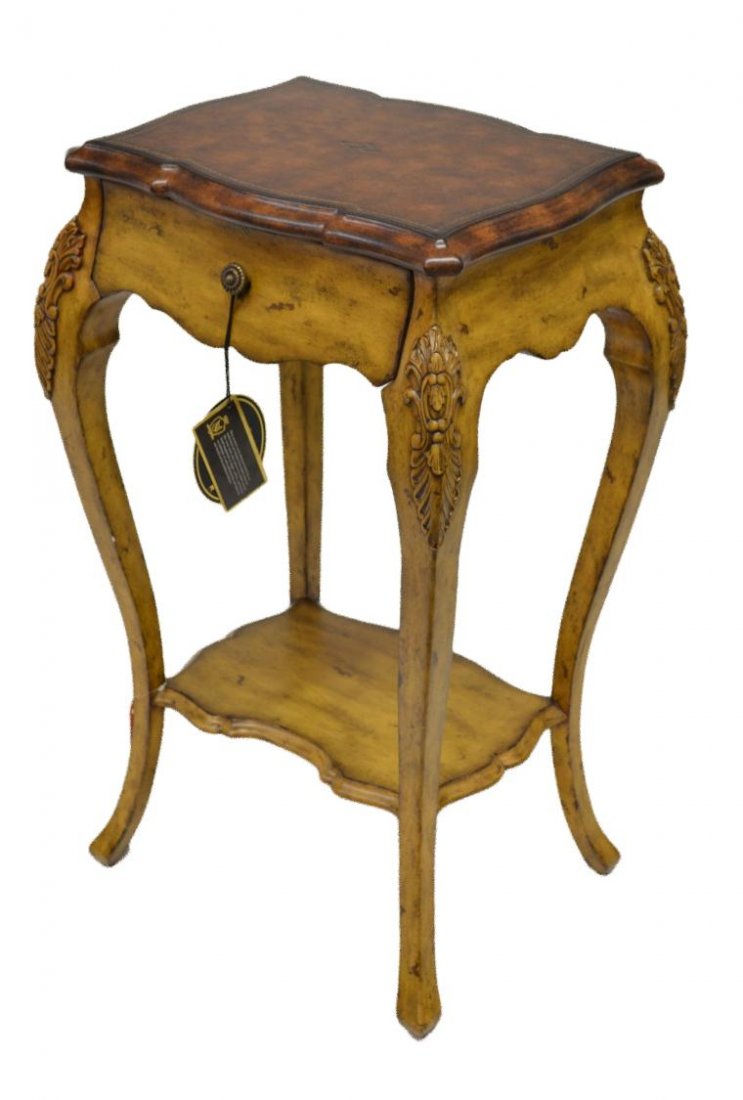 MAITLAND-SMITH LEATHER TOP LAMP TABLE: Maitland-Smith lamp table, a gilt accented leather shaped top with single drawer set on cabriole legs joined by lower shelf, 30.25"h, 13.25"w, 14.5"d **Provenance: Lou's Antiques and Fine Furnishings,