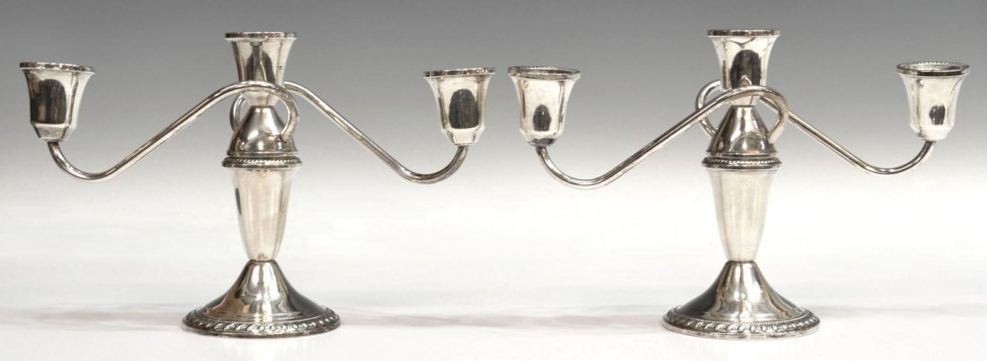 PAIR DUCHIN WEIGHTED STERLING SILVER CANDELABRA: (pair) Duchin sterling silver three-light candelabra, having scrolled branches and gadrooned borders, weighted, 6.75"h, 10.25"w, 1047 grams (all inclusive) Start Price: $50.00