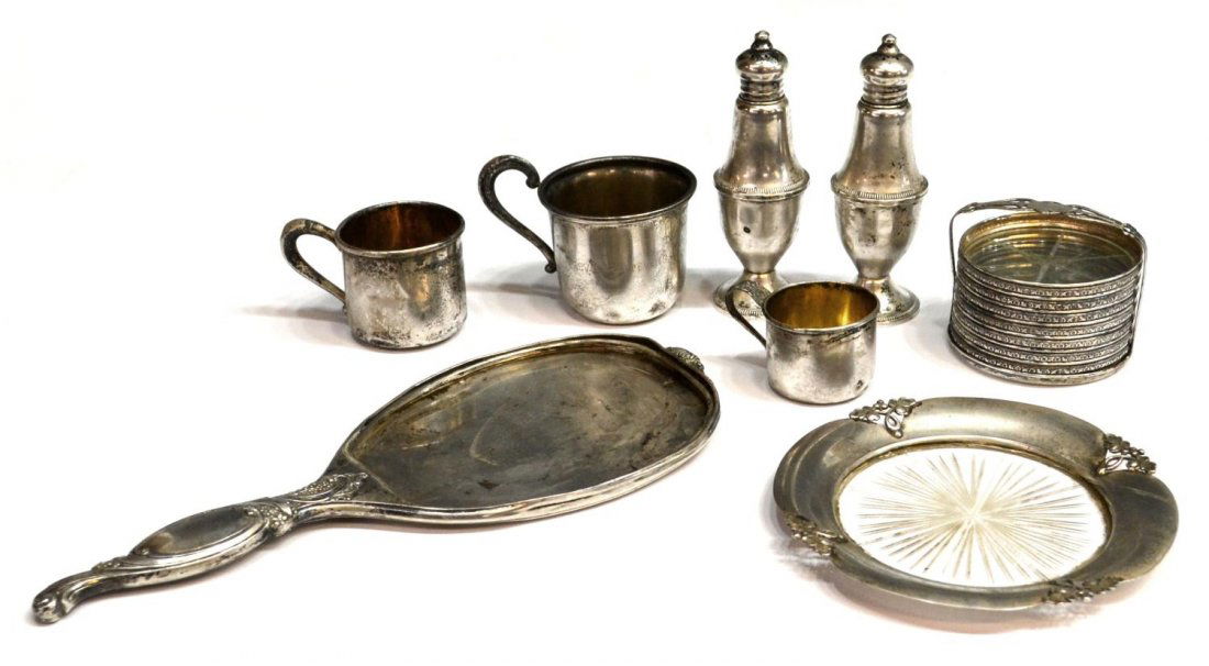 A STERLING SILVER COLLECTION, MOSTLY FOR SCRAP: (lot) A group of sterling, mostly for scrap, dents, loss and wear overall, including a (pair) weighted salt and pepper, (3) sterling child's cups, (1) hand mirror, lacking mirror, (set) glass bottom c