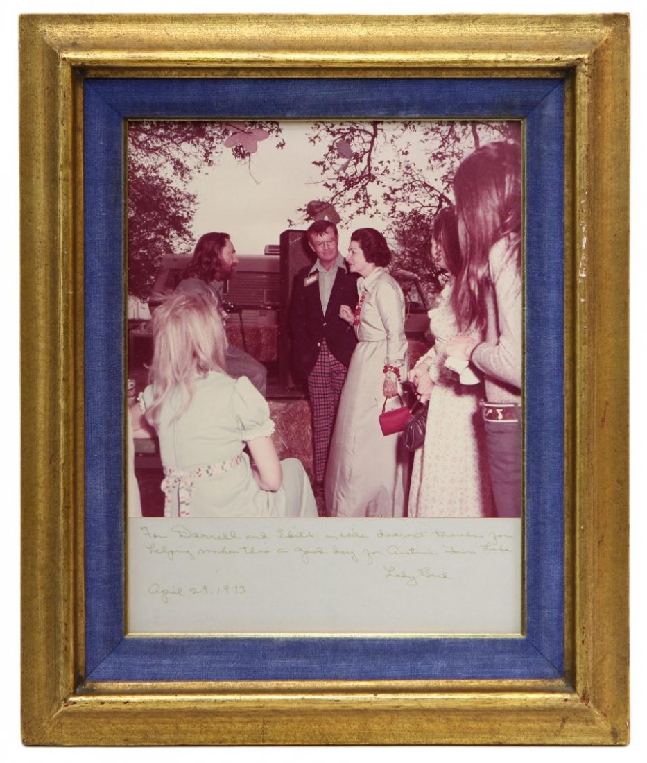 PHOTO: DARRELL ROYAL, WILLIE NELSON, LADY BIRD: Framed photo of Lady Bird Johnson (First Lady of the United States, wife of Lyndon B. Johnson, 36th President of the United States), conversing with Darrell Royal, Willie Nelson and others, inscribed 