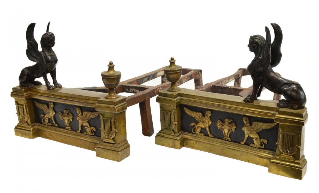 FRENCH EMPIRE STYLE PARCEL GILT BRONZE ANDIRONS: (pair) French Empire style parcel gilt bronze andirons in an Egyptian motif, a seated winged sphinx surmounting each, minor wear/loss, 11.5"h, 13"w, 35.5lbs total **Provenance: From the private collec