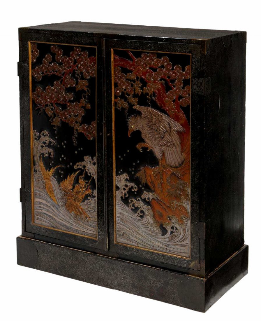 VINTAGE JAPANESE PARCEL GILT INLAID CHEST ON STAND: Vintage Japanese lacquer cabinet on base, a black ground scattered with mother-of-pearl flakes, two doors feature an eagle perched upon a pine branch, talons extended, peering at a fierce dragon fish 