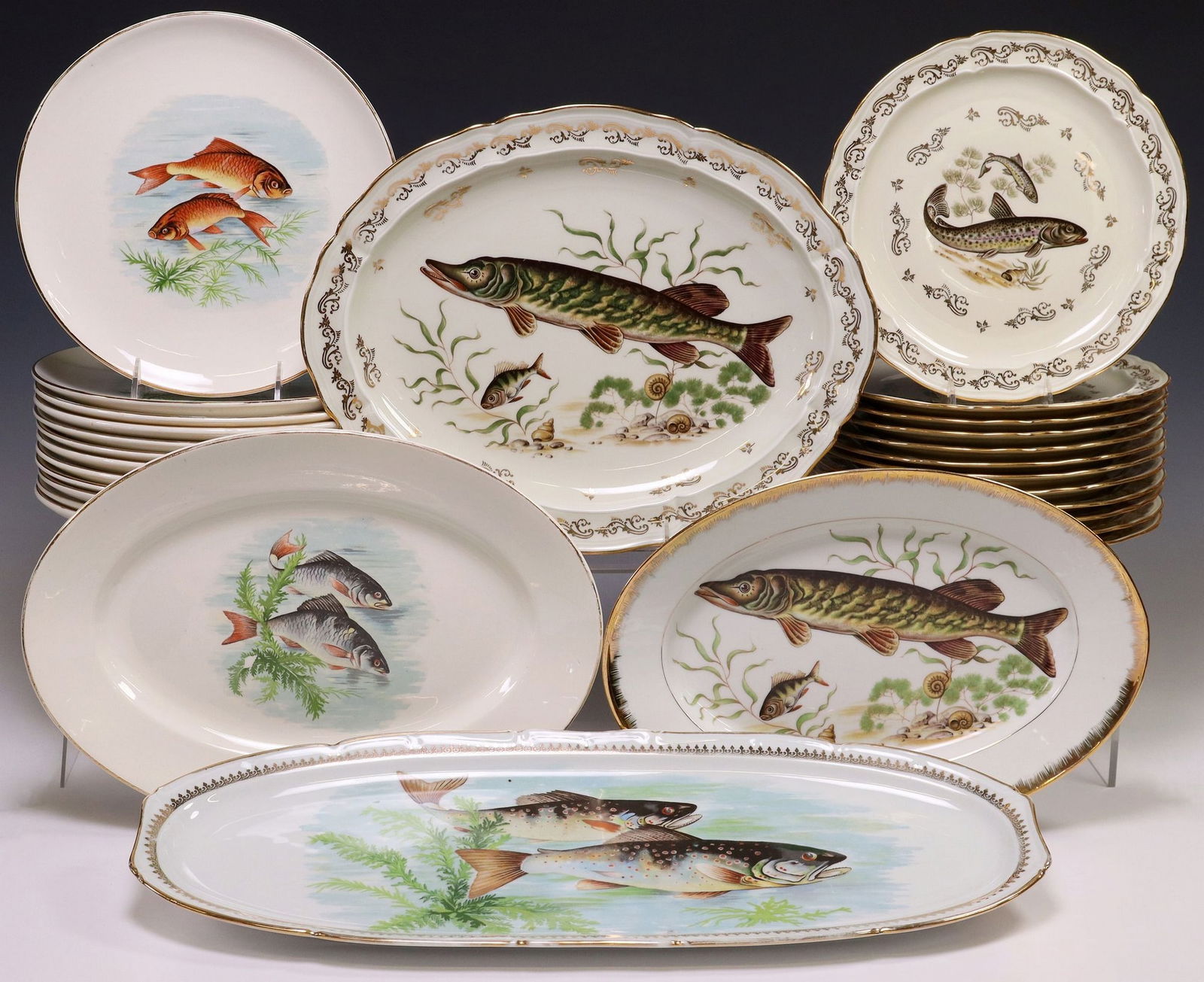(28) FRENCH PORCELAIN FISH SERVICES, BERNARDAUD LIMOGES & OTHER: (lot of 28) French parcel gilt porcelain fish services, each with varied transfer design depicting fish, (14) Bernardaud and Company, Limoges, most with maker's mark underfoot, (twelve) individual