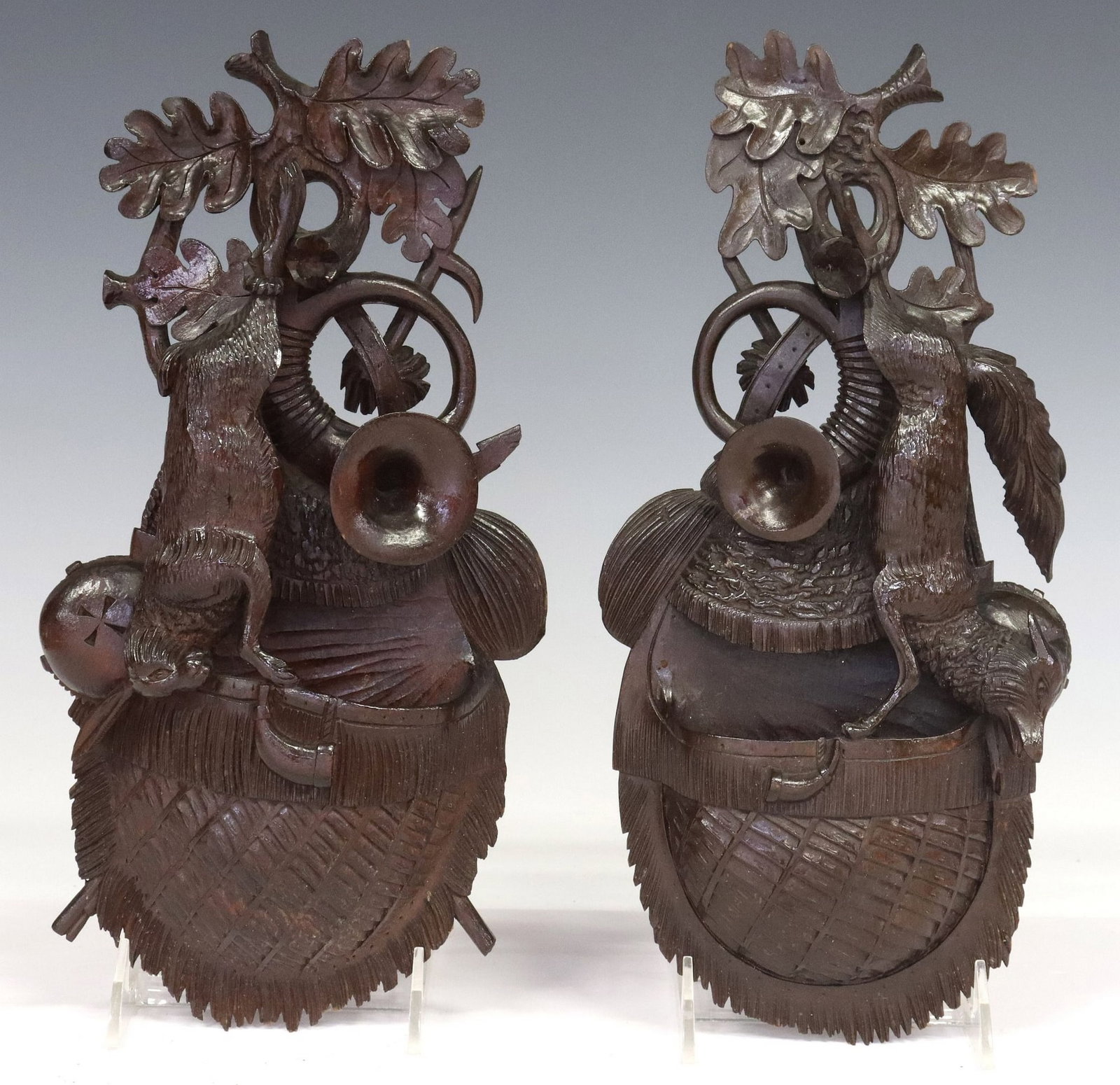 (2) BLACK FOREST CARVED GAME TROPHY WALL POCKETS: (lot of 2) Black Forest carved wood wall pockets, 19th c., crest of oak leaves and hunting horns above a game trophy, (one) a fox, (one) a hare, wall pocket modeled as a net game bag, typical sma