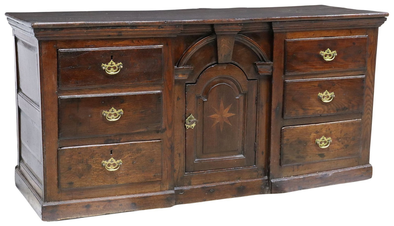 GEORGE II STAR PARQUETRY OAK KITCHEN DRESSER BASE, 18TH C.: English George II oak kitchen dresser base, 18th c., plank top comprised of three boards, recessed arched cabinet door with star parquetry, flanked by six drawers, paneled sides and back, on conformin