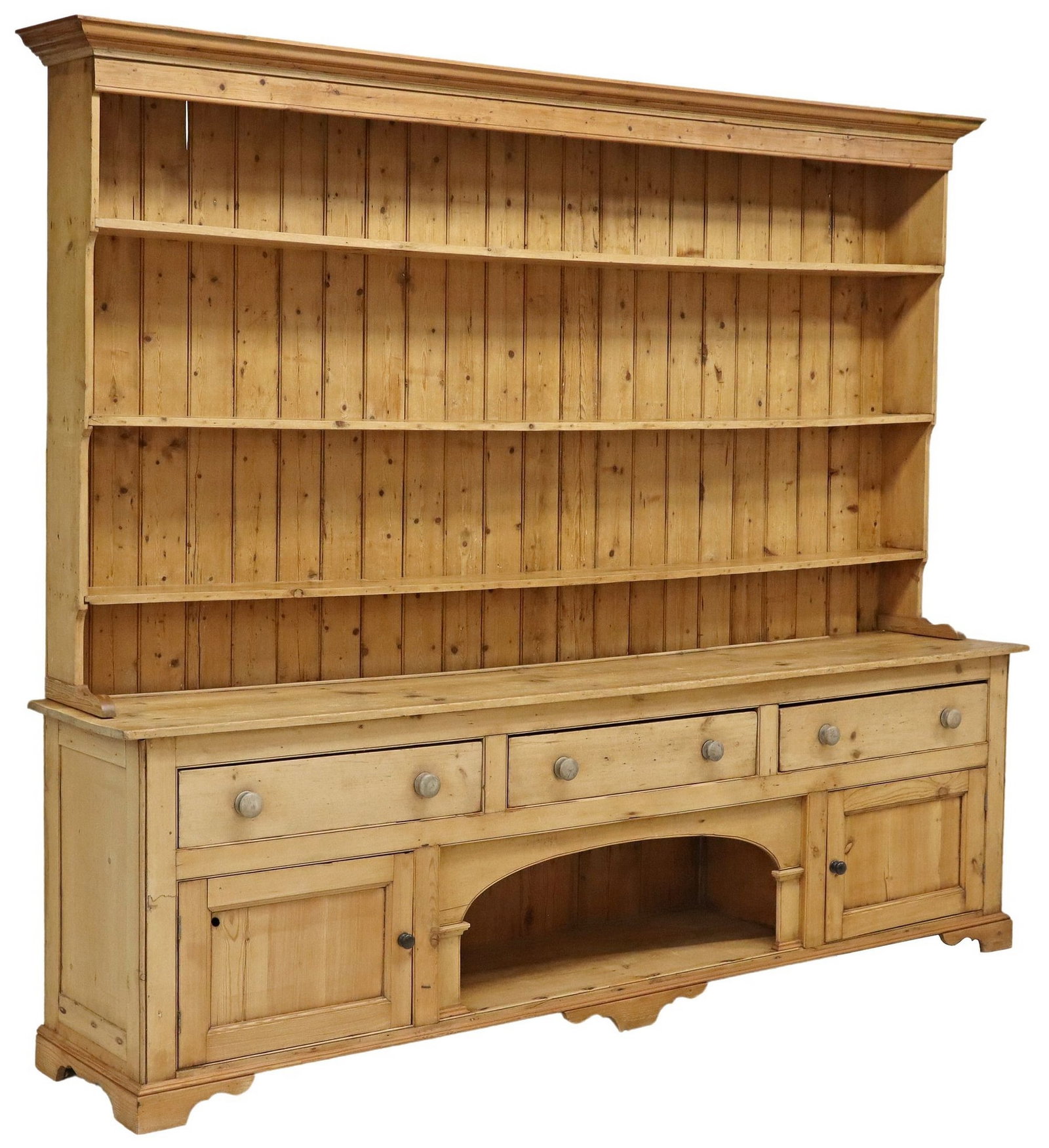 LARGE RUSTIC PINE 2-PART WELSH DRESSER KITCHEN CUPBOARD, 112"L: Rustic pine Welsh dresser/ kitchen cabinet, early 20th c., structure in two parts, having stepped cornice, over three open shelves, rising on lower case fitted with three drawers, above central arched