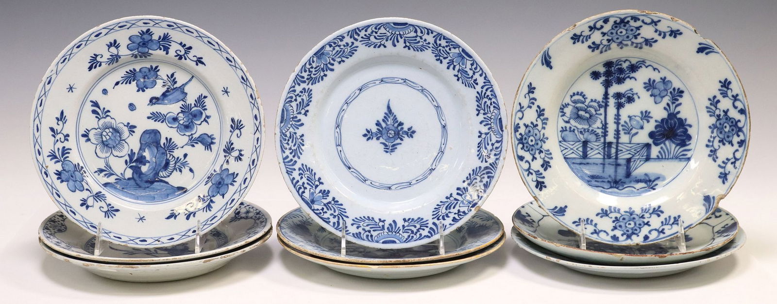 (9) DELFT BLUE & WHITE CHINOISERIE DECORATED TIN-GLAZED PLATES: (lot of 9) Delft tin-glazed earthenware plates, late 18th c., various Chinoiserie floral patterns, bird and garden landscape scenes, only (two) matched with remnants of yellow rim, typical small