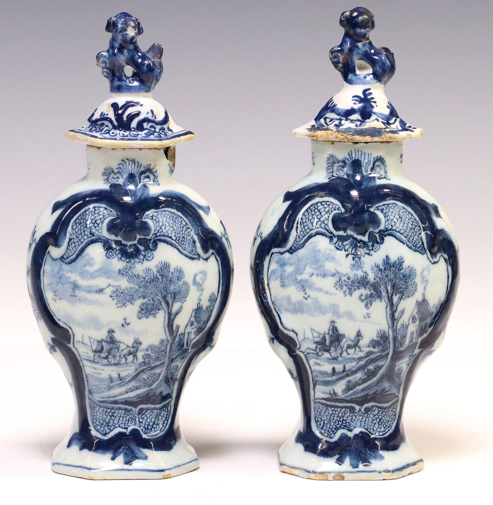 (2) DUTCH DELFT BLUE & WHITE BALUSTER VASES & COVERS: (pair) Dutch Delft tin-glazed earthenware vases, late 18th c., compressed baluster-form, painted to one side with horse-drawn cart in a country landscape within a molded cartouche, reverse with p