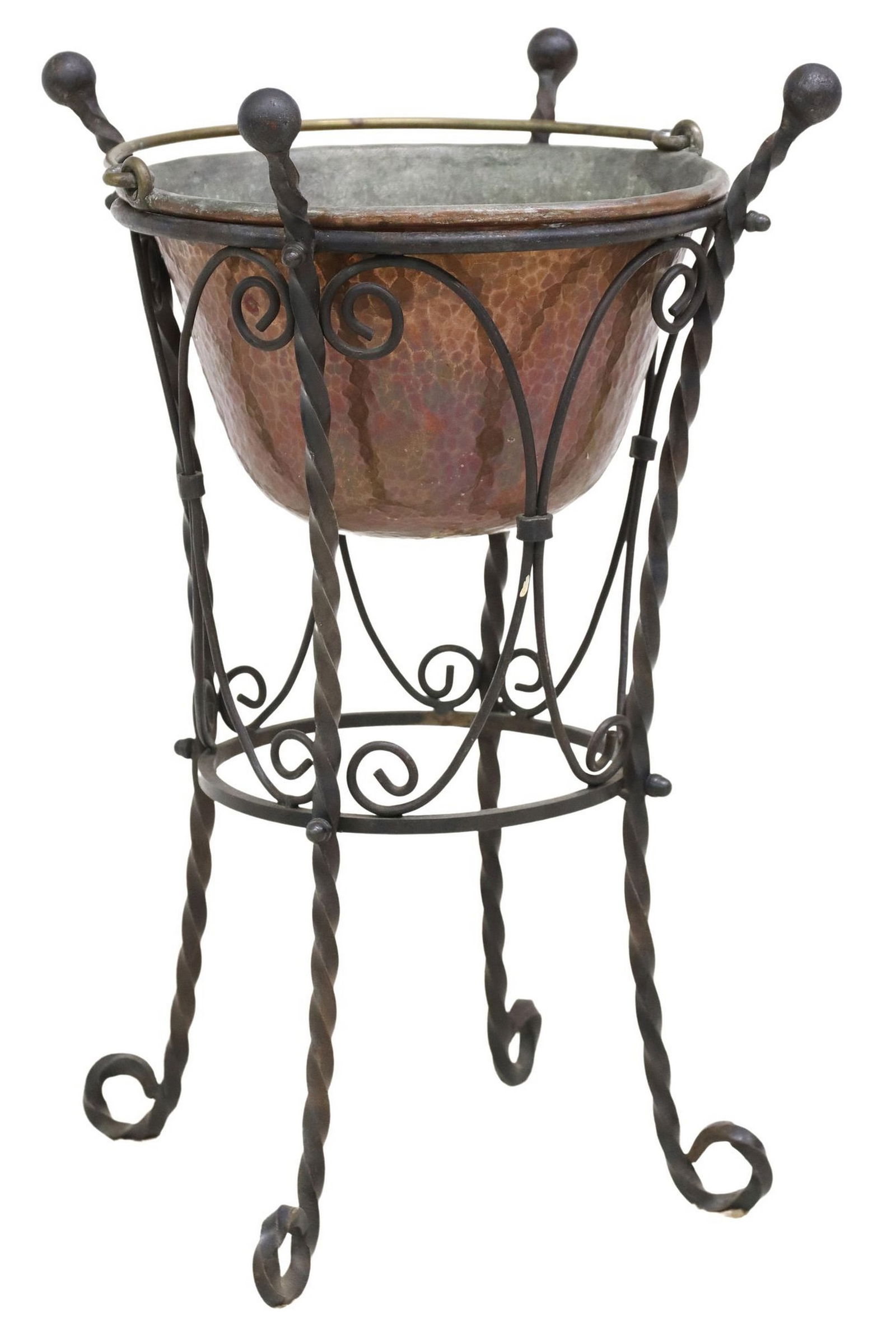 ITALIAN HAMMERED COPPER PLANTER ON WROUGHT IRON STAND: Italian copper planter on stand, 20th c., planter with hammered exterior, gilt metal bail handle, rising on twisted and scrolled wrought iron frame, overall: approx 22.5"h, 12"w, 12&quo