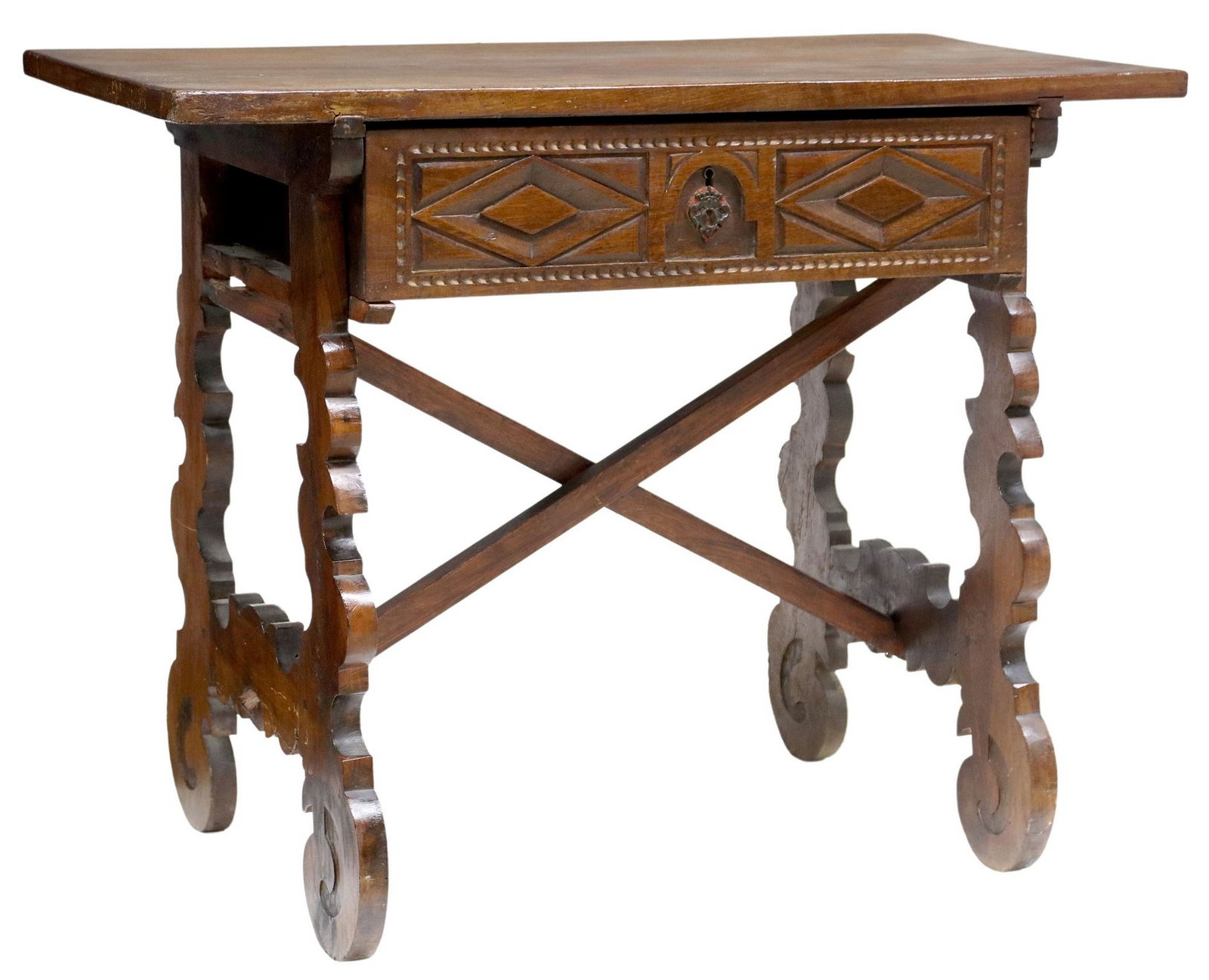 SPANISH BAROQUE STYLE WALNUT TRESTLE TABLE: Spanish Baroque style walnut table, 20th c., incorporating earlier elements, single-board top, over frieze drawer with carved front, scrolled trestle end supports joined by center stretchers, approx 3