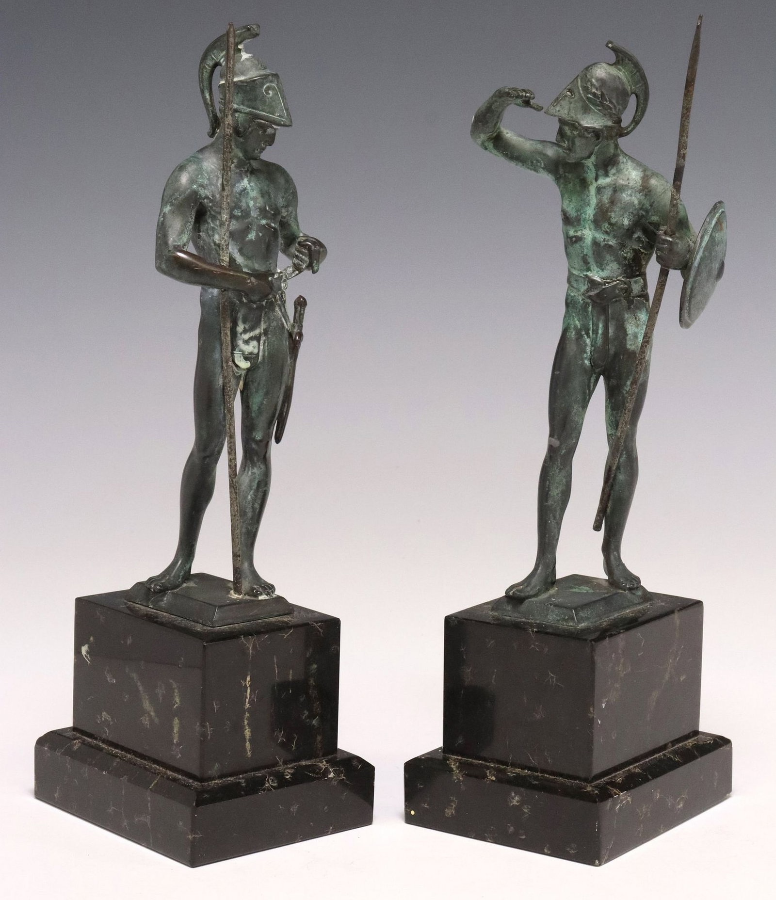(2) CLASSICAL STYLE VERDIGRIS PATINATED BRONZE FIGURES, ROMAN WARRIORS: (lot of 2) Classical style patinated bronze figural sculptures, each modeled as a Roman warrior with helmet and lance, in a verdigris patina, rising on marble plinth, largest: approx 11.75"h