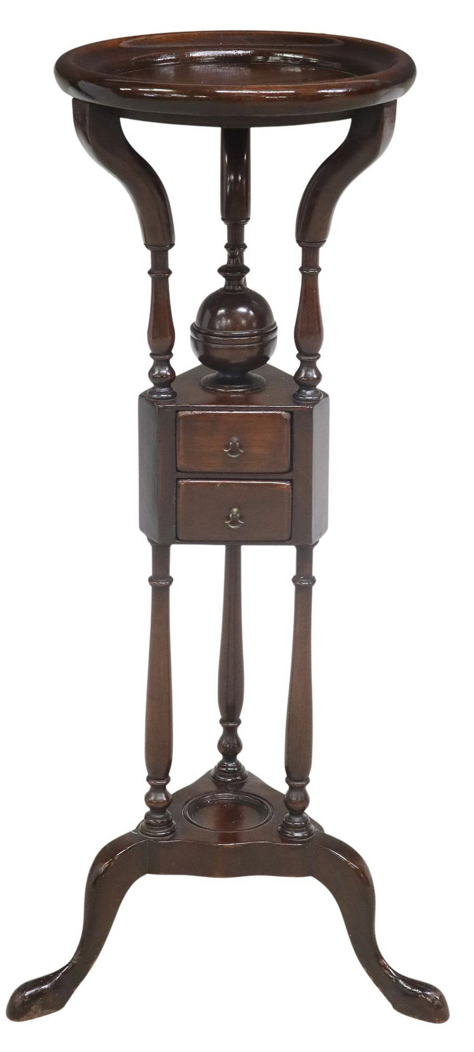 ENGLISH GEORGIAN STYLE MAHOGANY WIG-STAND: English mahogany wig stand/ plant stand, 20th c., having circular top over lidded compartment with pointed finial topper, two small drawers, rising on turned supports, ending on tripartite base, appro