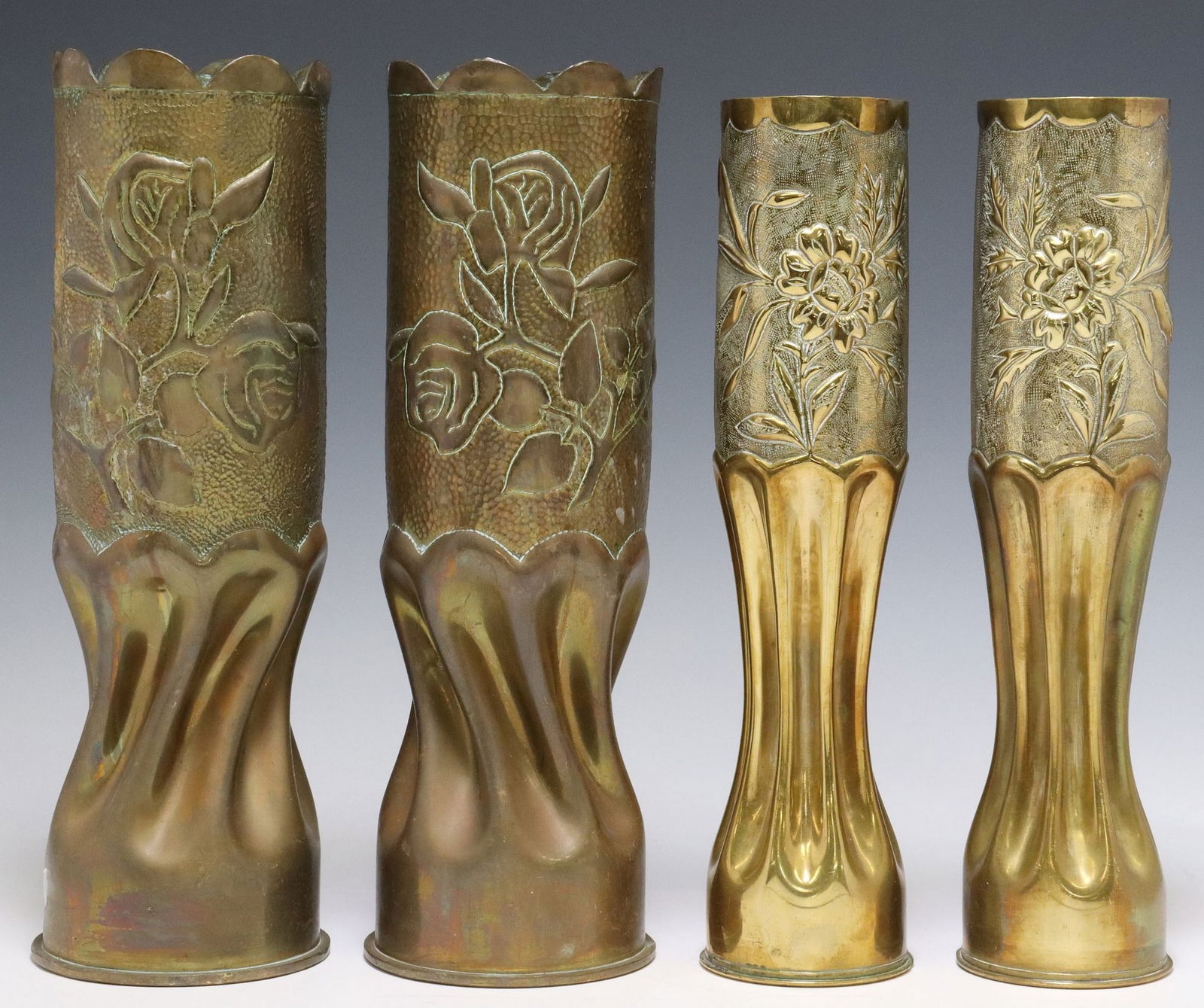 (4) FRENCH WWI & WWII-ERA TRENCH ART ARTILLERY SHELL VASES: (lot of 4) French WWI-era trench art vases, fashioned from artillery shells, each having repousse floral motifs on textured ground, rising on waisted stem, including: (2) large WWII-era vases, with sc