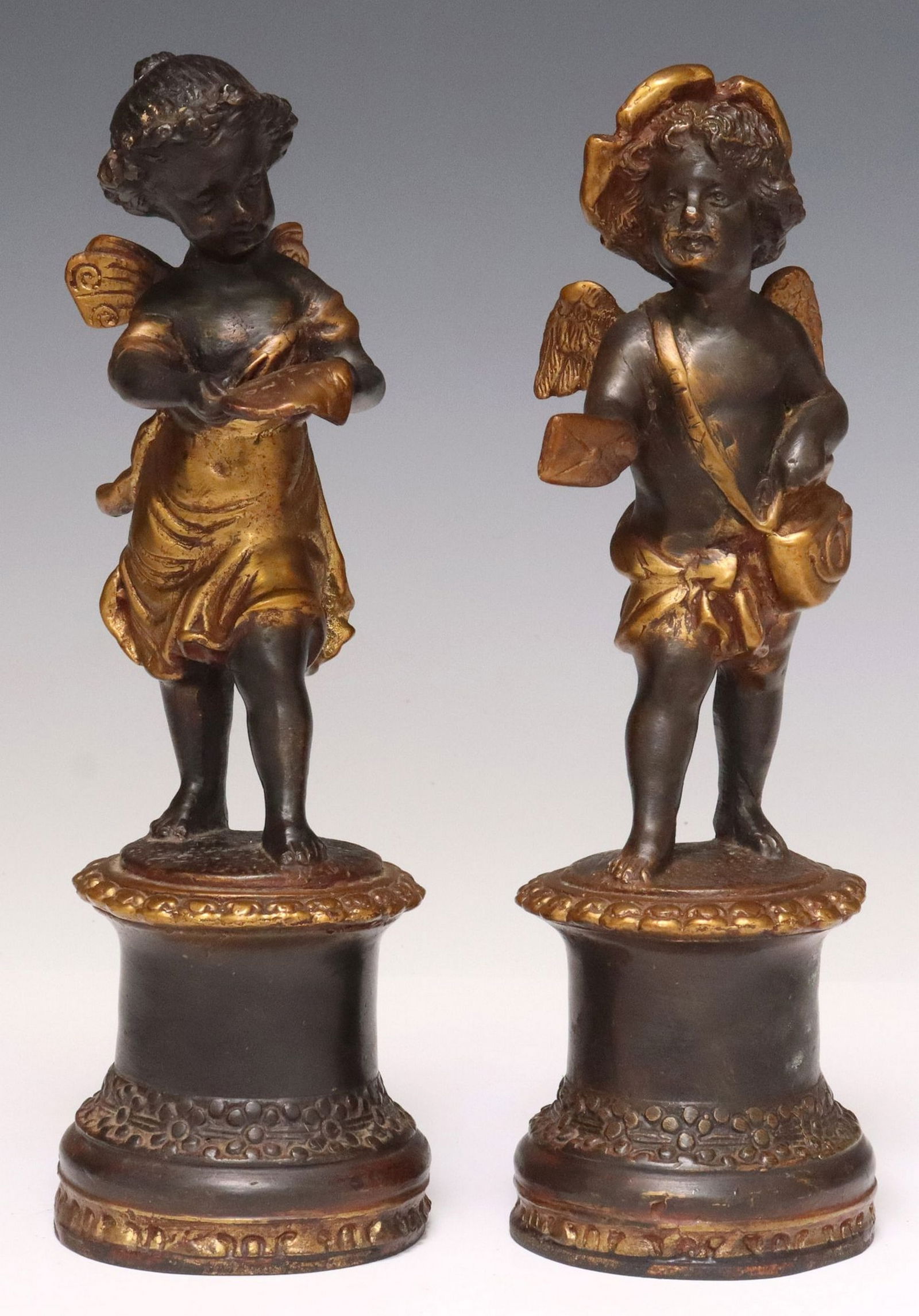 (2) AFTER AUGUSTE MOREAU GILT BRONZE CHERUB SCULPTURES: (pair) Patinated gilt bronze sculptures, Cherubs, base signed in cast after Auguste Moreau (French, 1834-1917), the young girl reading a document, the young boy with envelope and messenger bag, rising